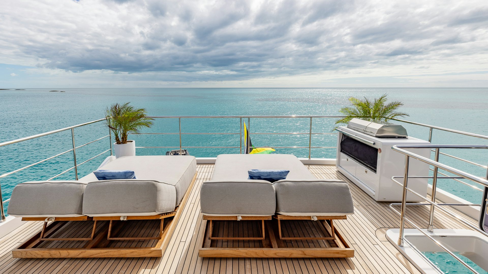 a deck with a view of the ocean and a boat aboard PIER PRESSURE Yacht for Charter