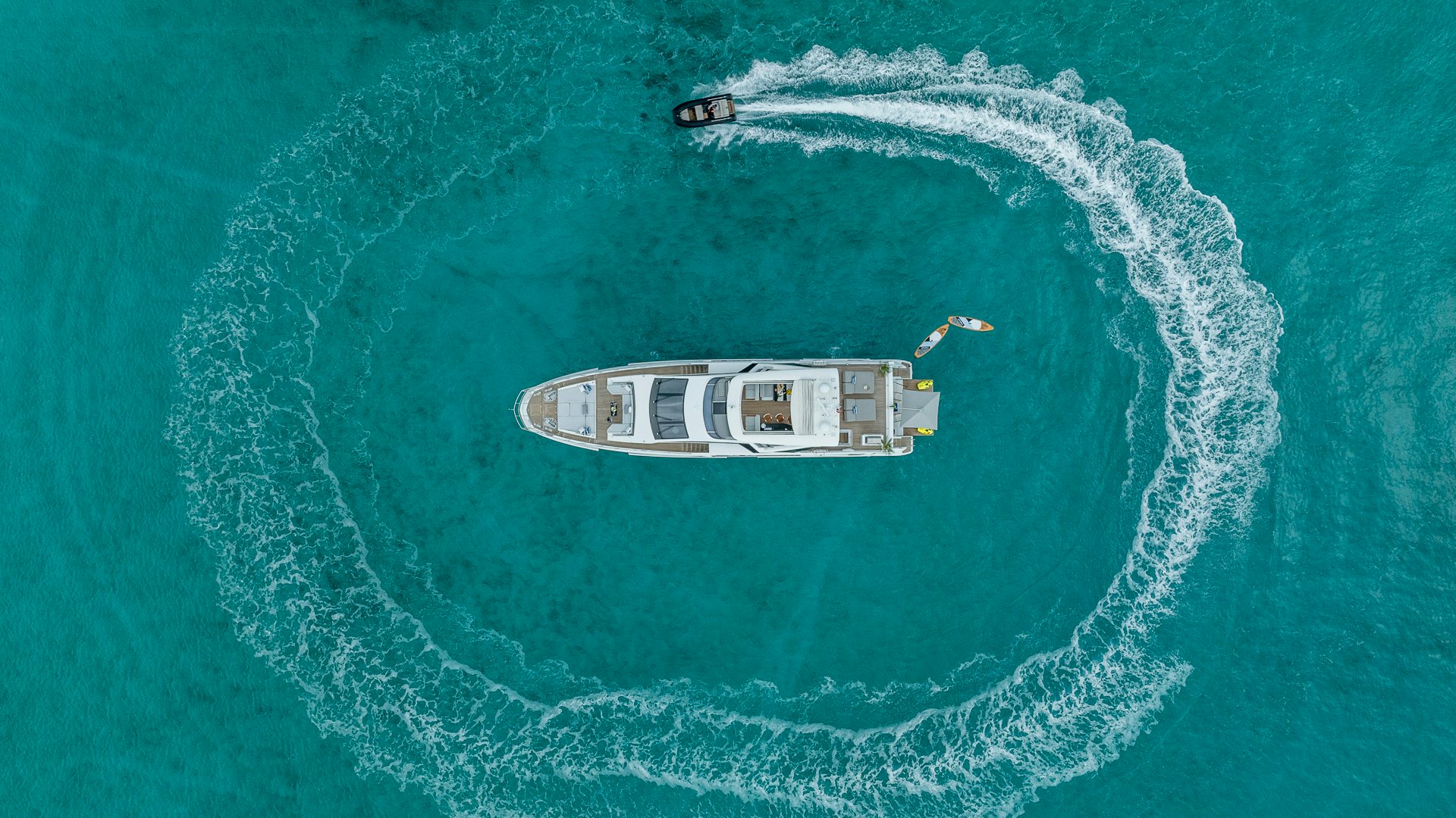 a helicopter flying over a boat in the ocean aboard PIER PRESSURE Yacht for Charter
