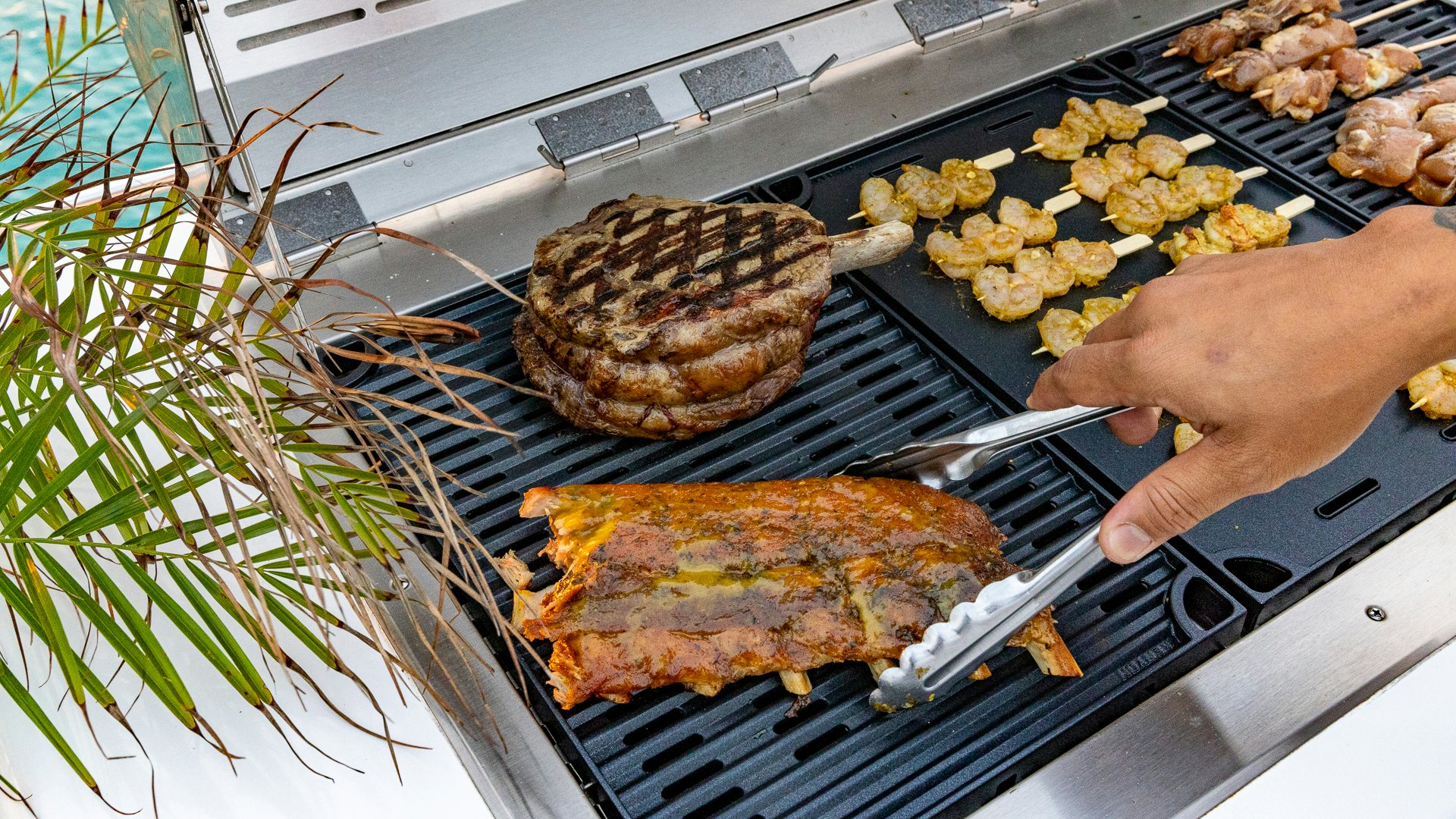 a person grilling meat on a grill aboard PIER PRESSURE Yacht for Charter