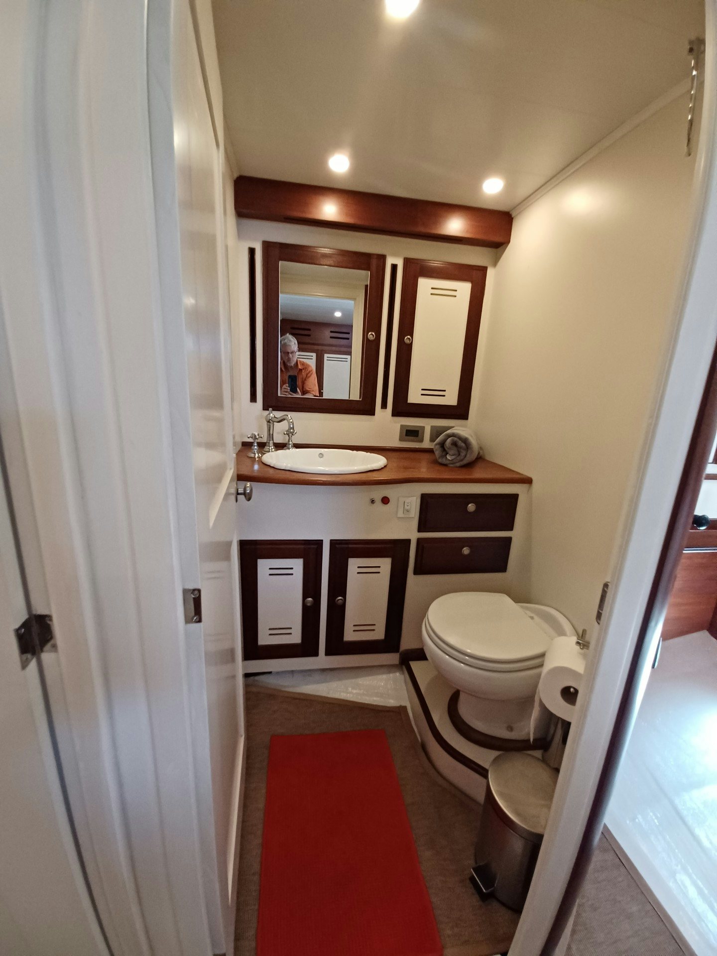a bathroom with a sink toilet and a mirror aboard TARA Yacht for Sale