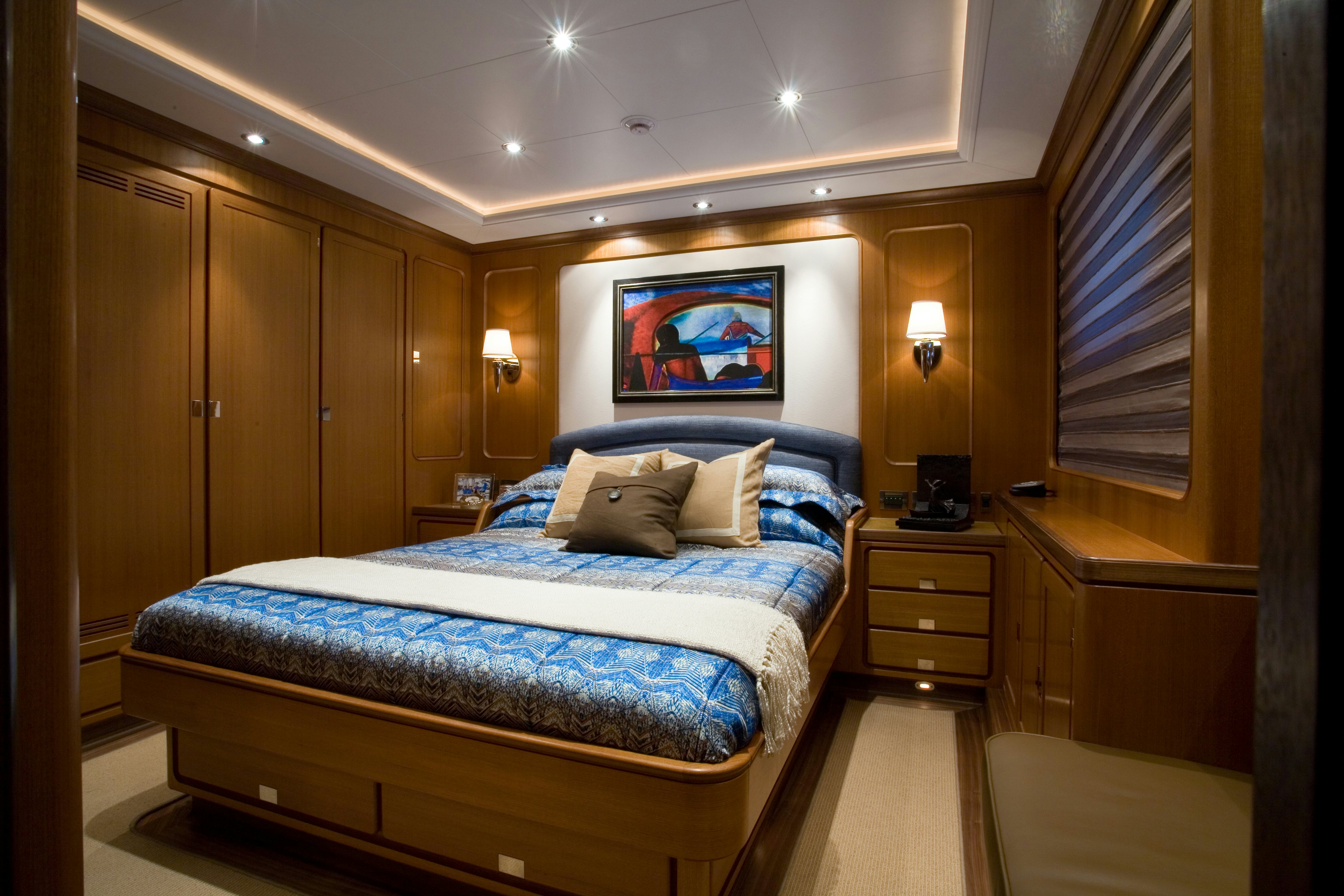 a bedroom with a bed and a television on the wall aboard TAMSEN Yacht for Sale