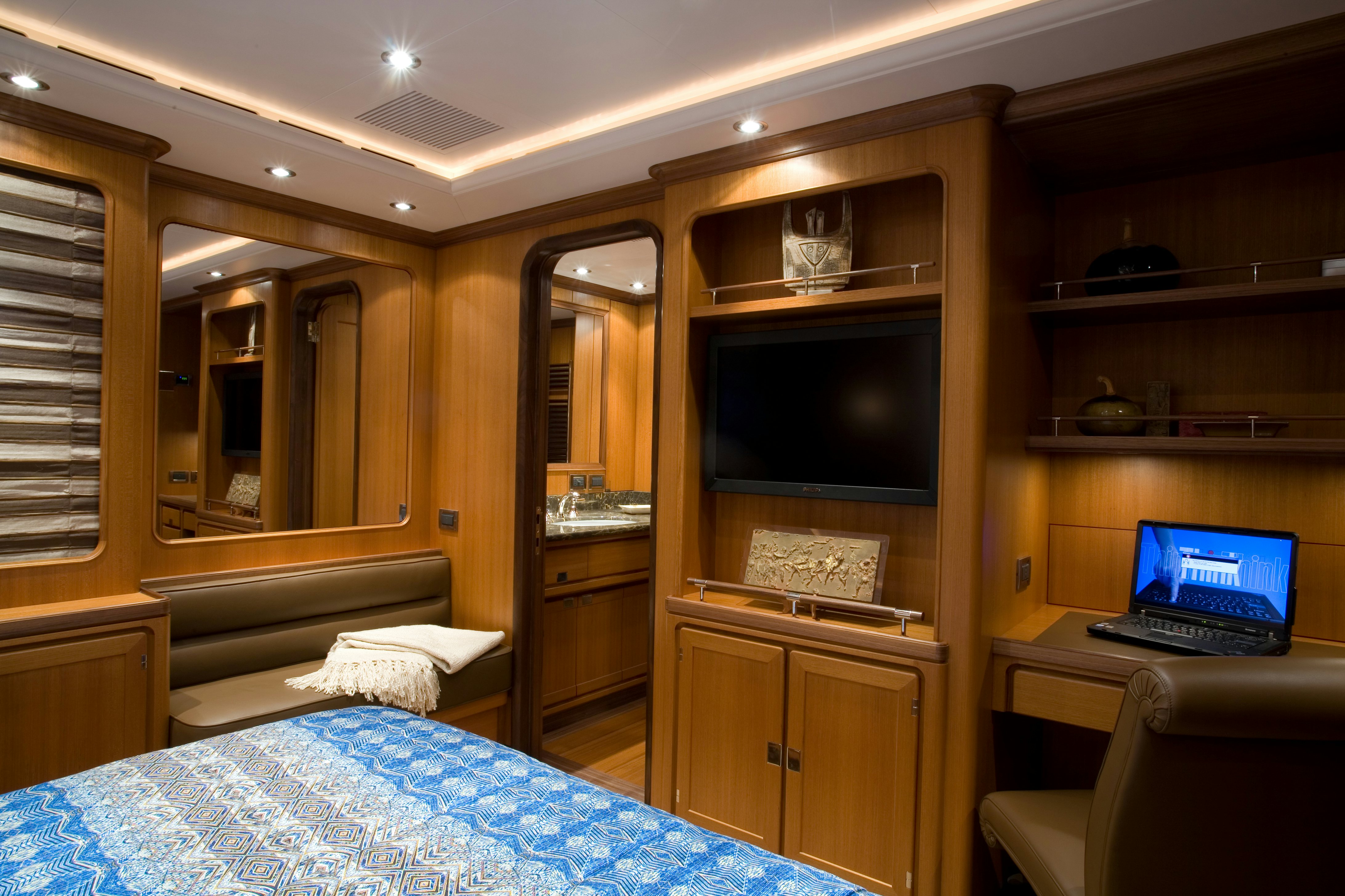 a bedroom with a laptop on the bed aboard TAMSEN Yacht for Sale
