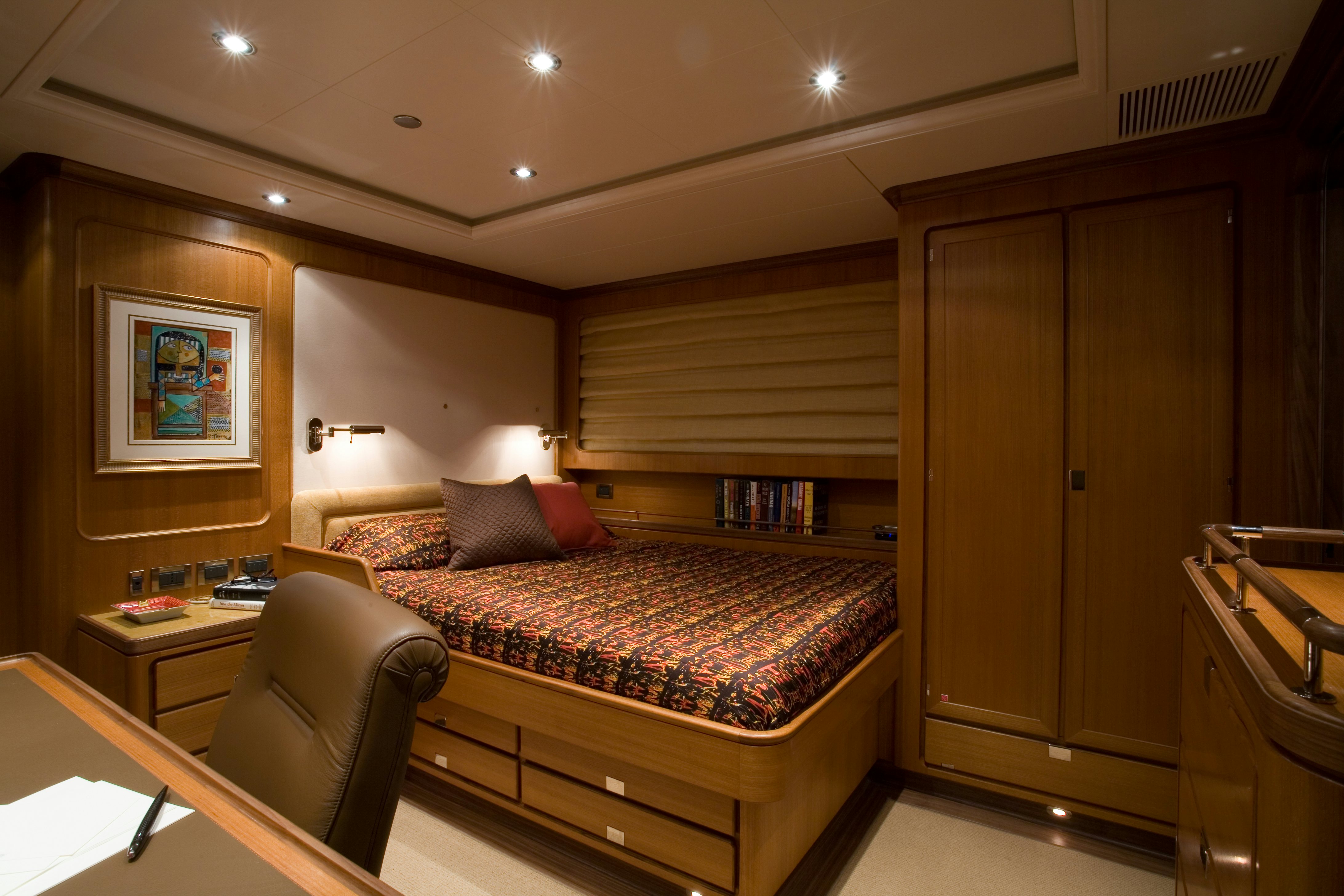 a bedroom with a bed and desk aboard TAMSEN Yacht for Sale