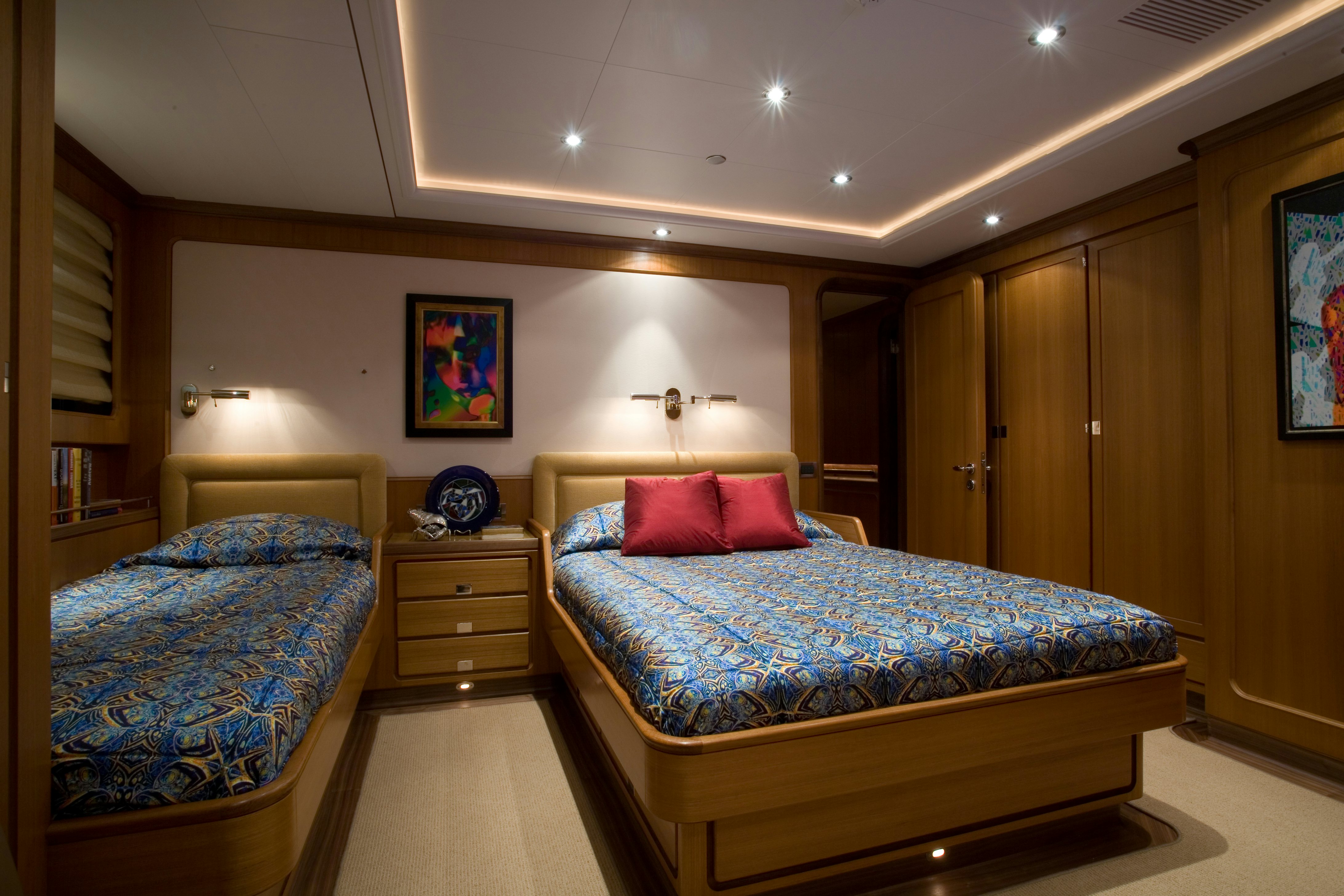 a bedroom with a bed and a dresser aboard TAMSEN Yacht for Sale