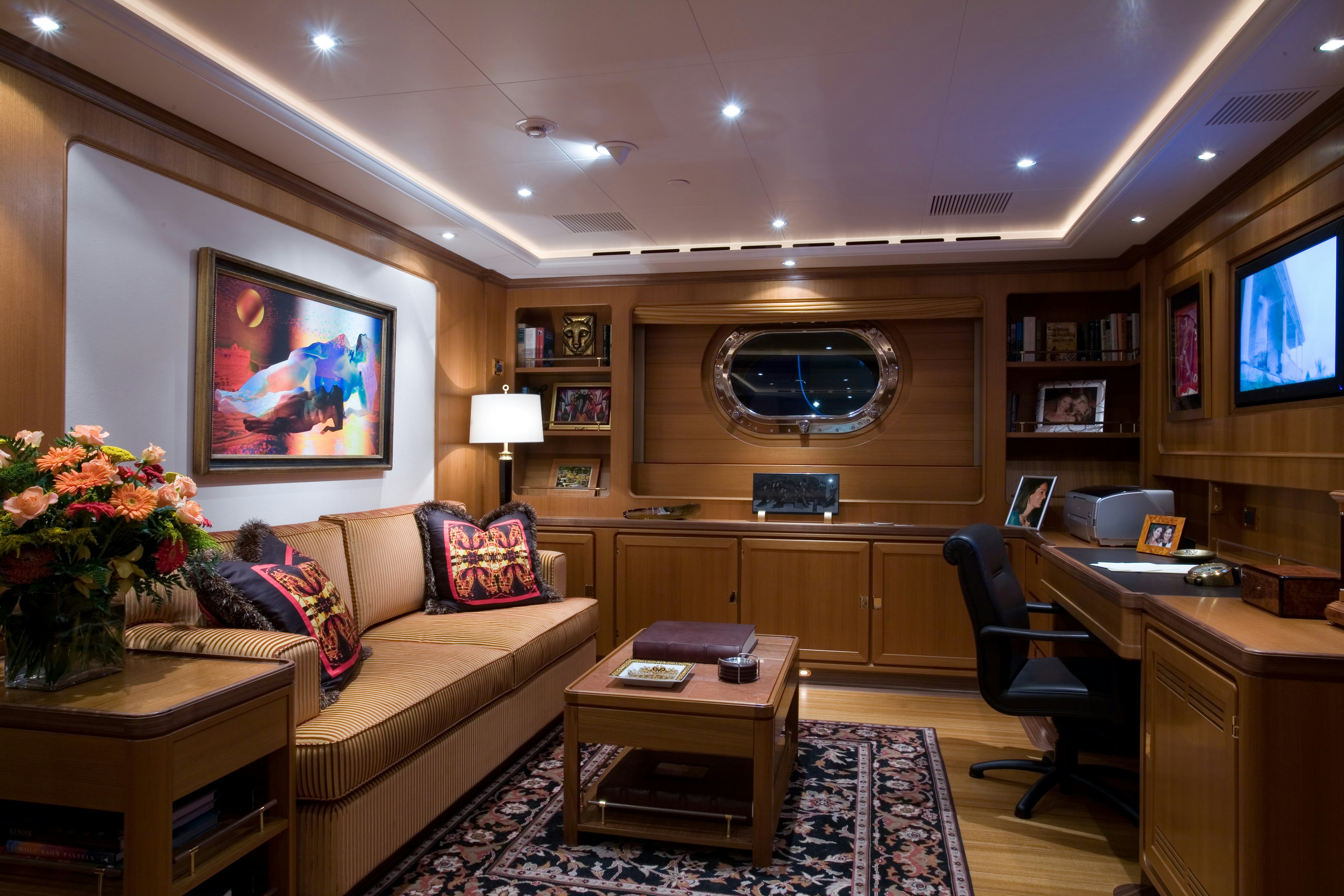 a living room with a couch and a television aboard TAMSEN Yacht for Sale