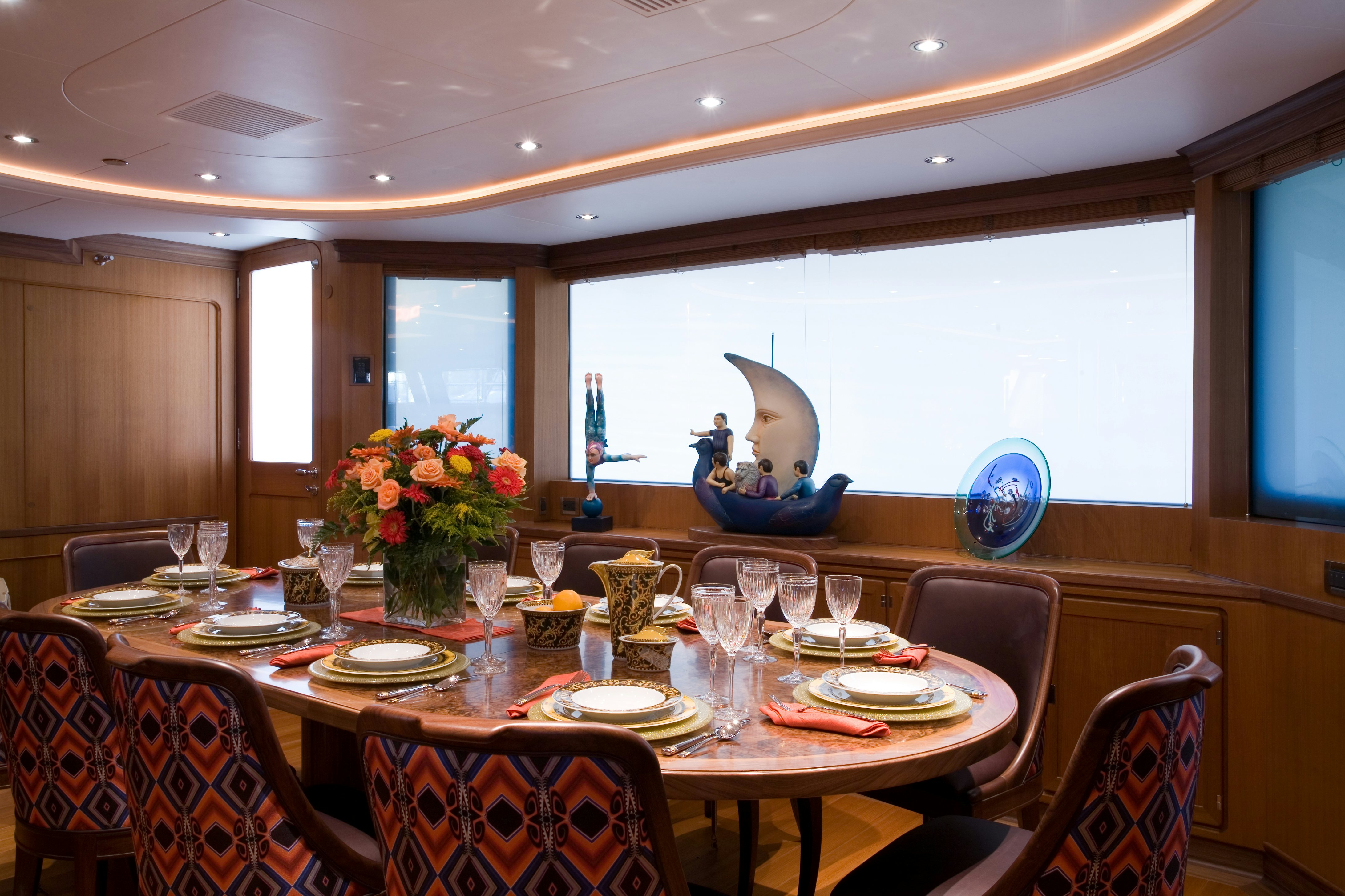 a dining room with a table set for a dinner aboard TAMSEN Yacht for Sale