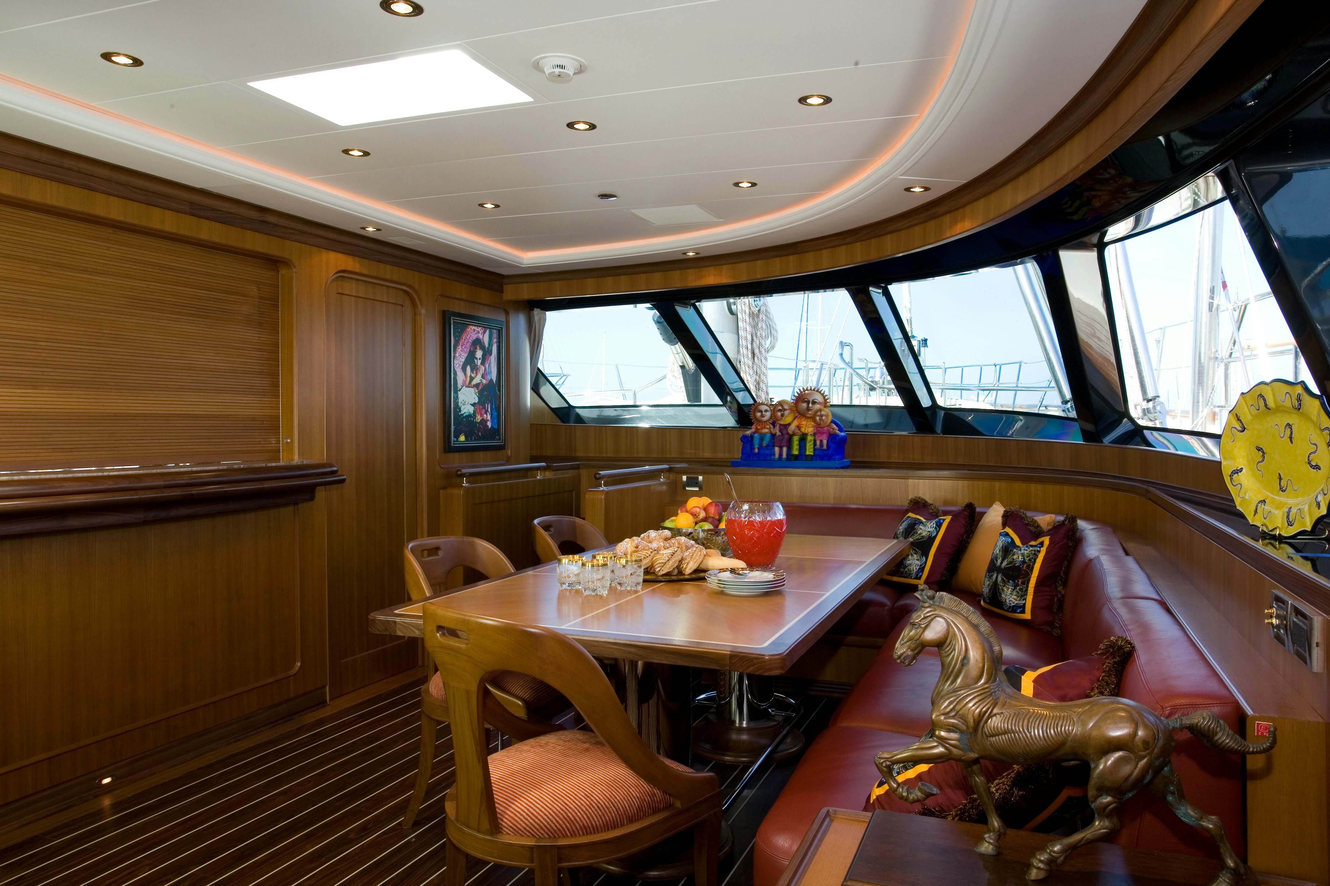 a dining room with a table and chairs aboard TAMSEN Yacht for Sale