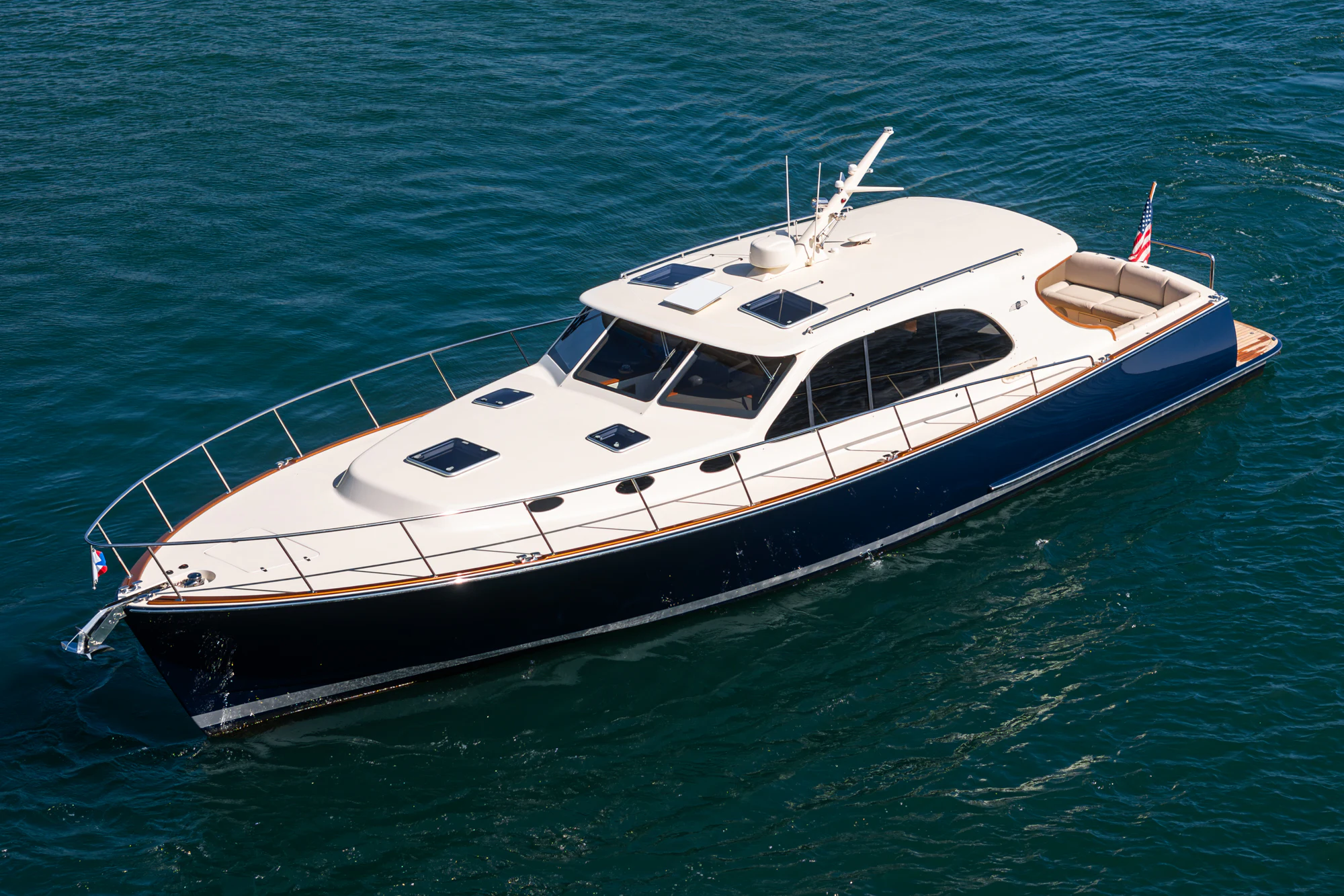 a white boat in the water aboard PIPE DREAM Yacht for Sale