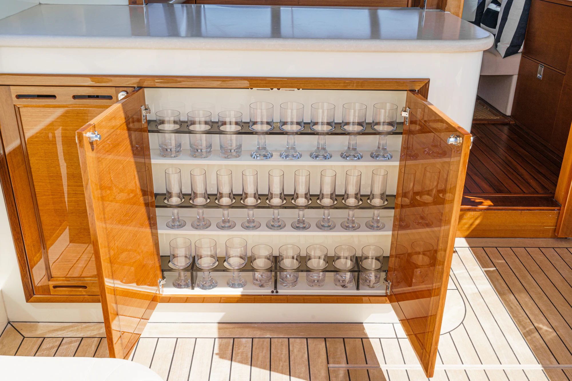 a glass cabinet with many beakers aboard PIPE DREAM Yacht for Sale