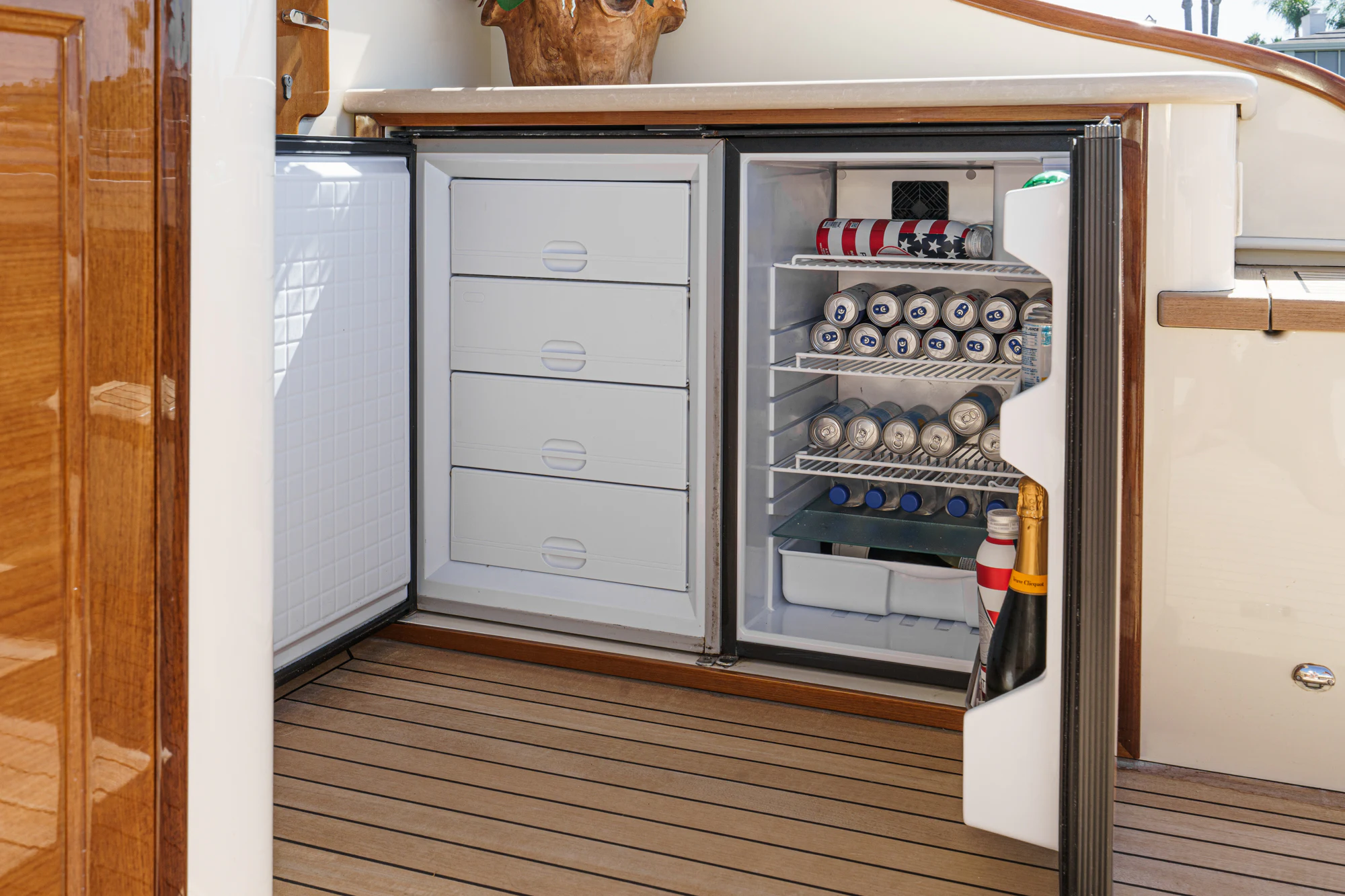 a refrigerator with a door open aboard PIPE DREAM Yacht for Sale