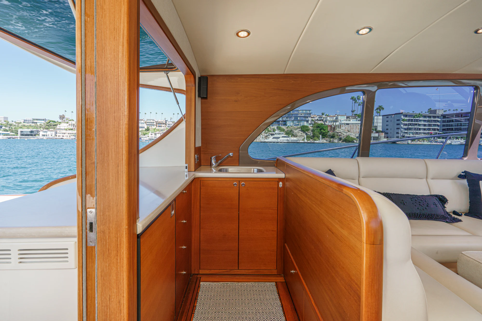 a room with a view of the ocean and a boat aboard PIPE DREAM Yacht for Sale