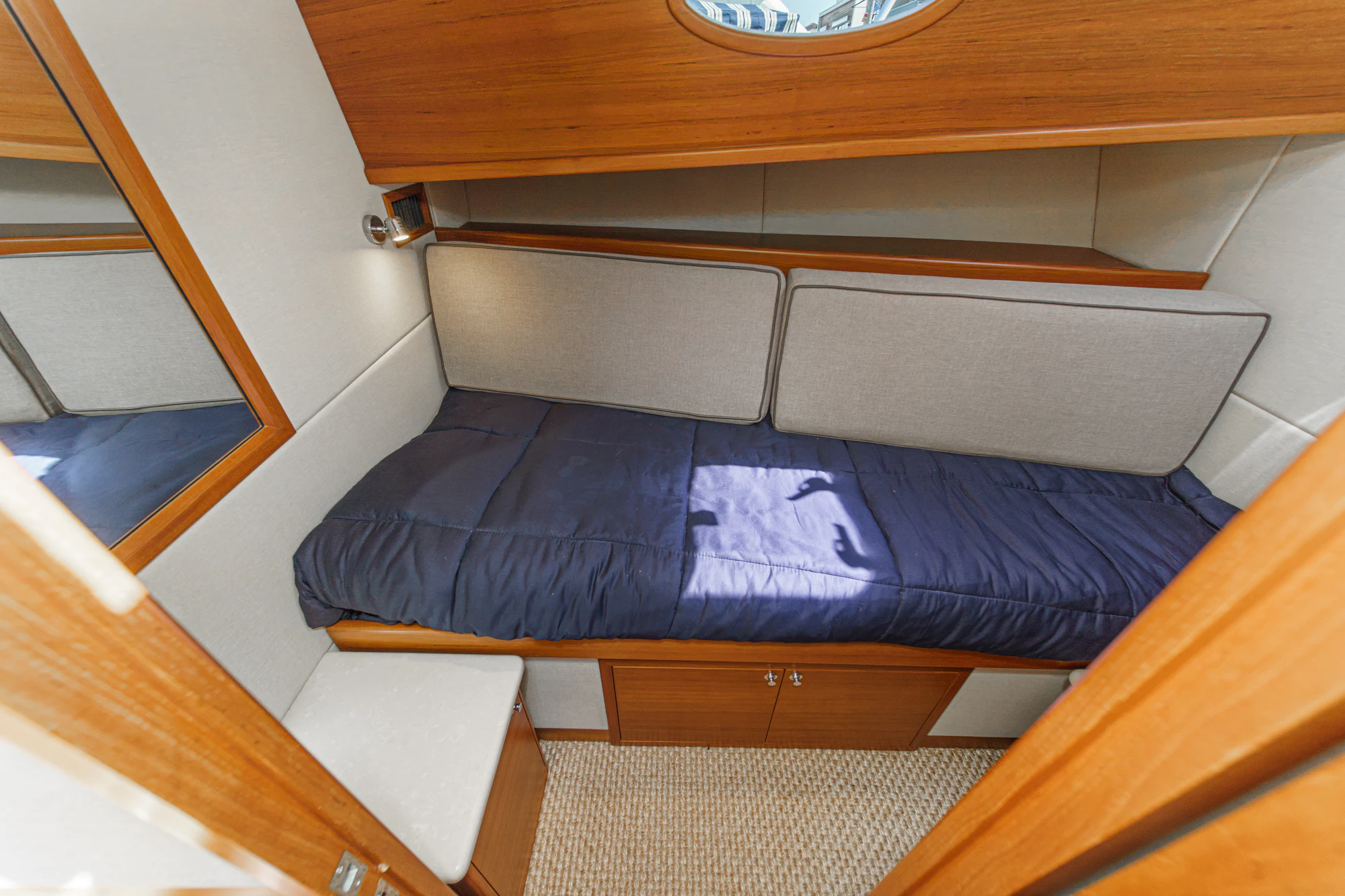 a bed with a blue cover aboard PIPE DREAM Yacht for Sale