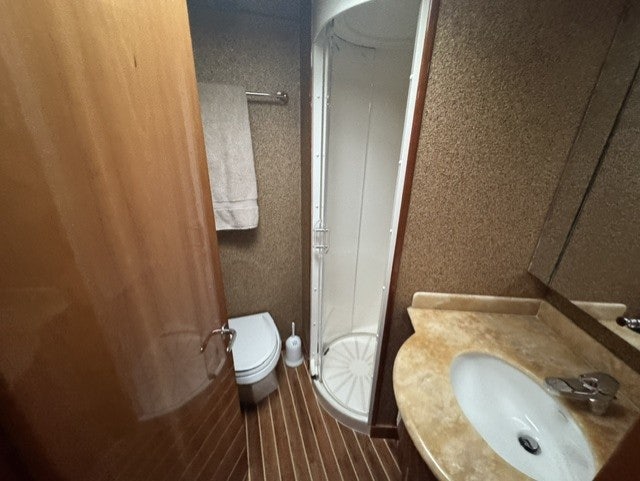 a bathroom with a sink and toilet aboard TRUE GRIT Yacht for Sale