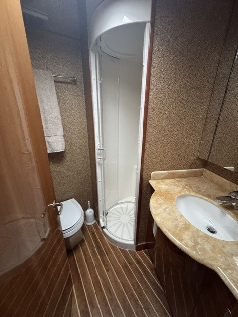 a bathroom with a shower and sink aboard TRUE GRIT Yacht for Sale