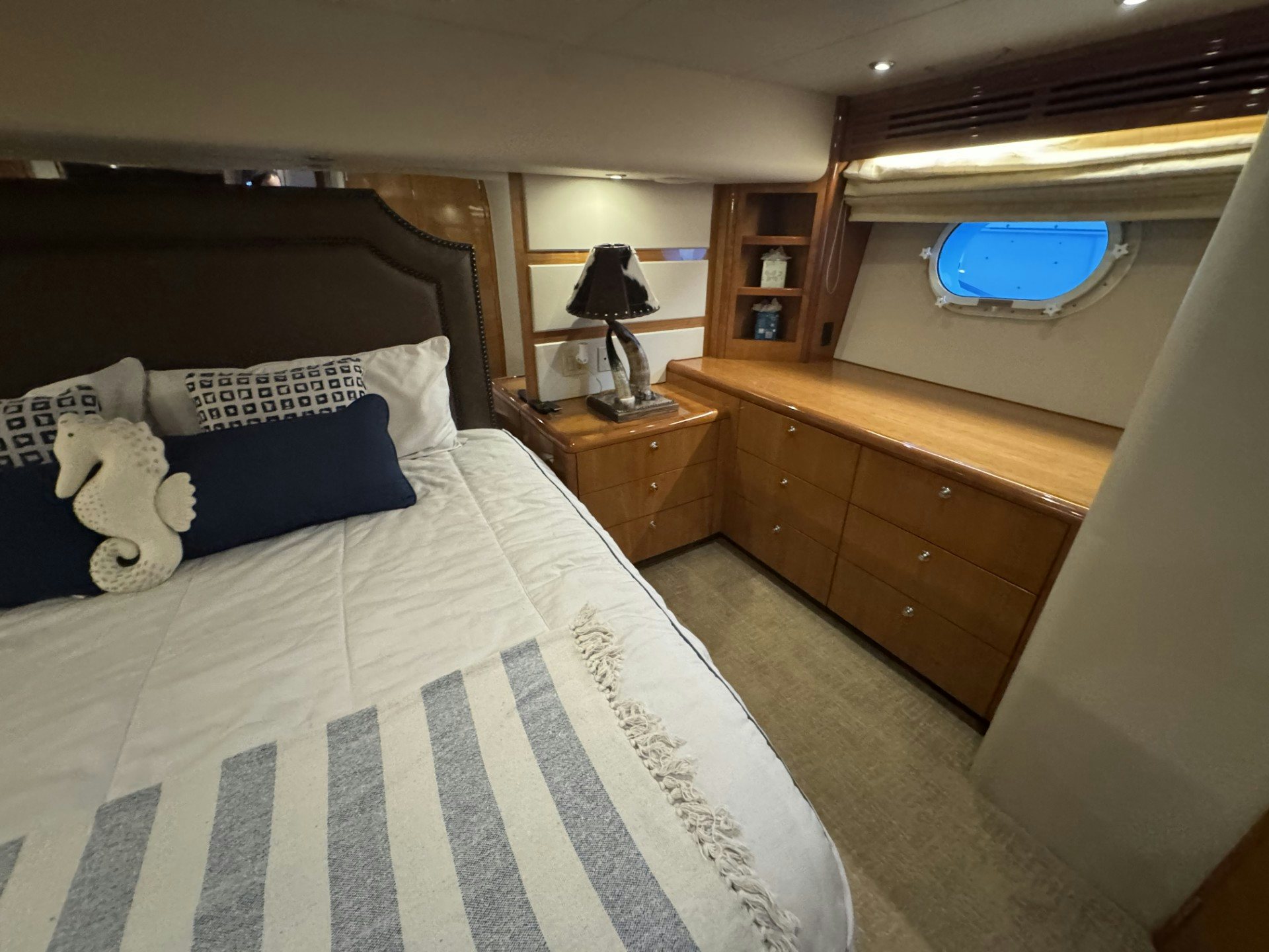 a bed with a blue and white checkered blanket aboard TRUE GRIT Yacht for Sale