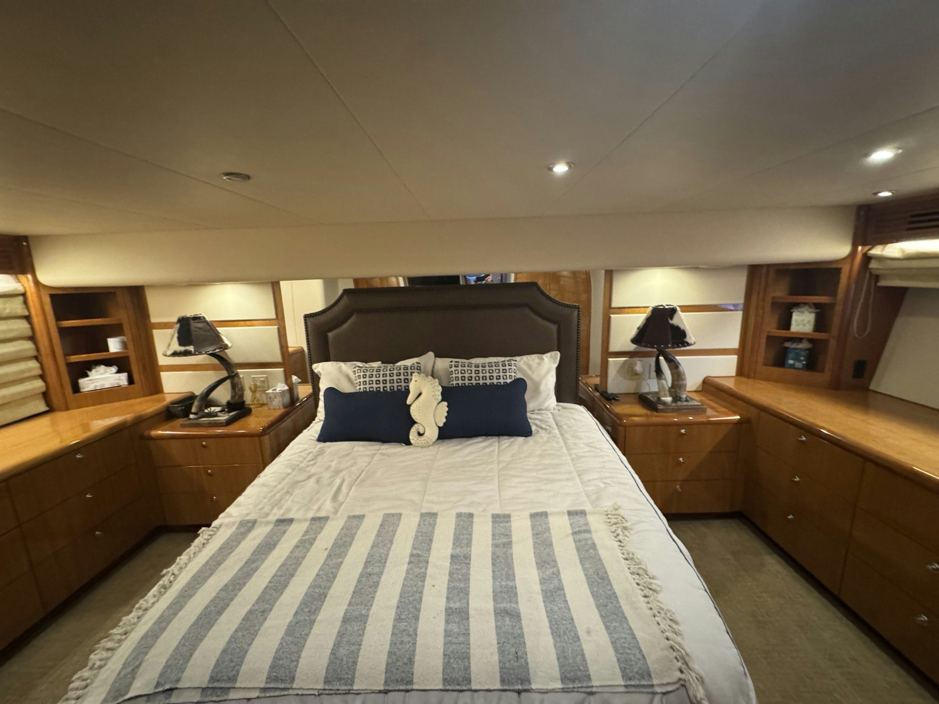 a bed with a blue and white checkered blanket aboard TRUE GRIT Yacht for Sale