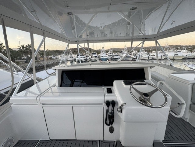 a white boat with a black object on it aboard TRUE GRIT Yacht for Sale