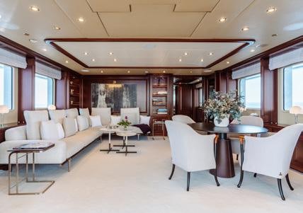 a living room with a table and chairs aboard HEMABEJO Yacht for Charter