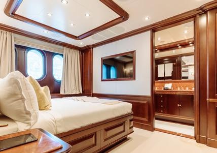 a room with a bed and a mirror aboard HEMABEJO Yacht for Charter