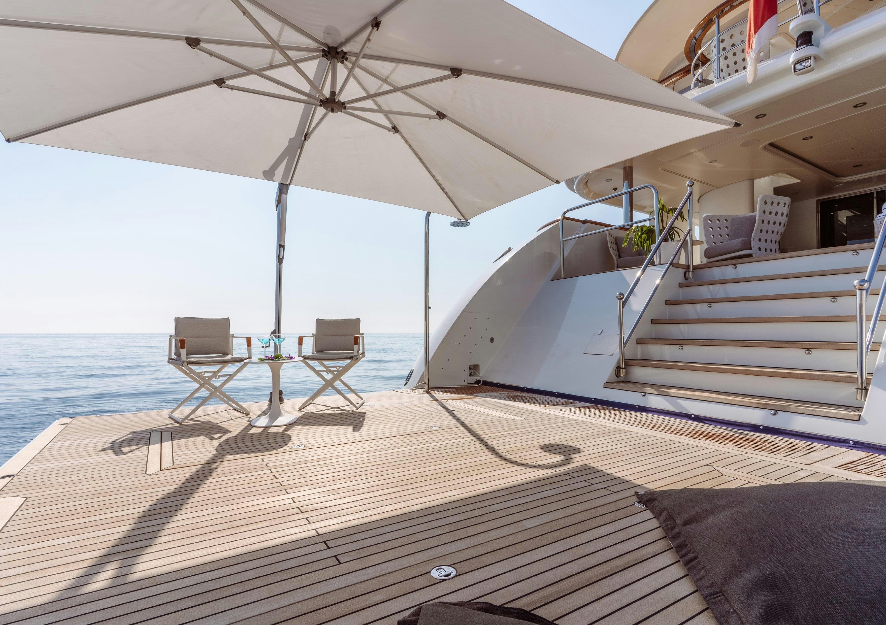 a patio with a table and chairs on it aboard HEMABEJO Yacht for Charter