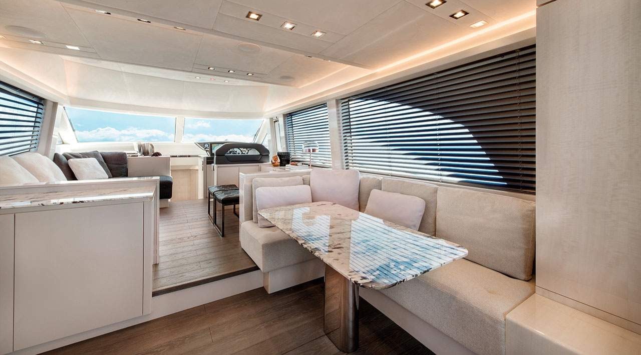 a living room with a couch and a large window aboard GRACE Yacht for Sale