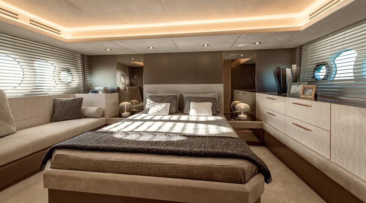 a bedroom with a bed and a couch aboard GRACE Yacht for Sale