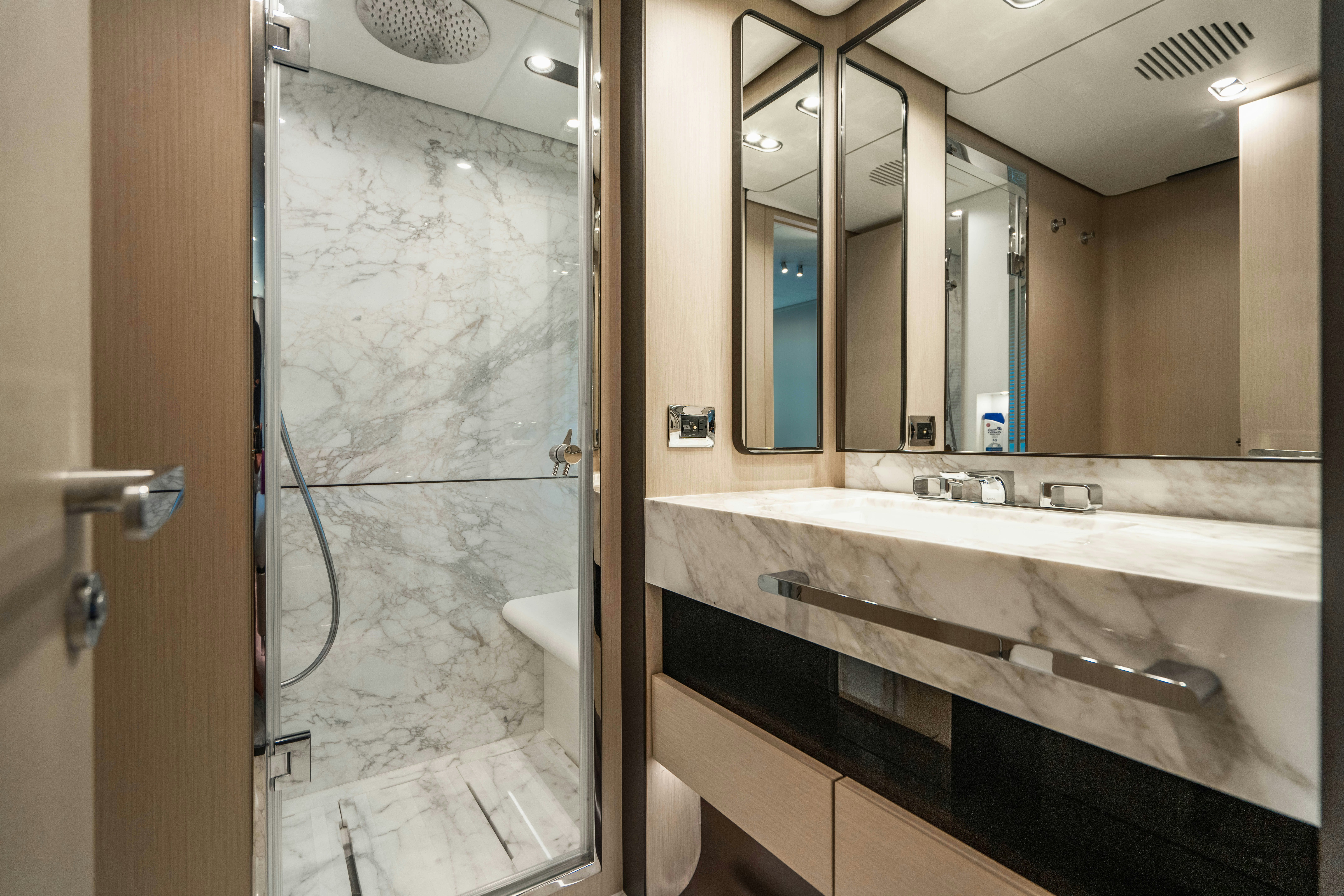a bathroom with a glass shower aboard CARPE DIEM Yacht for Charter