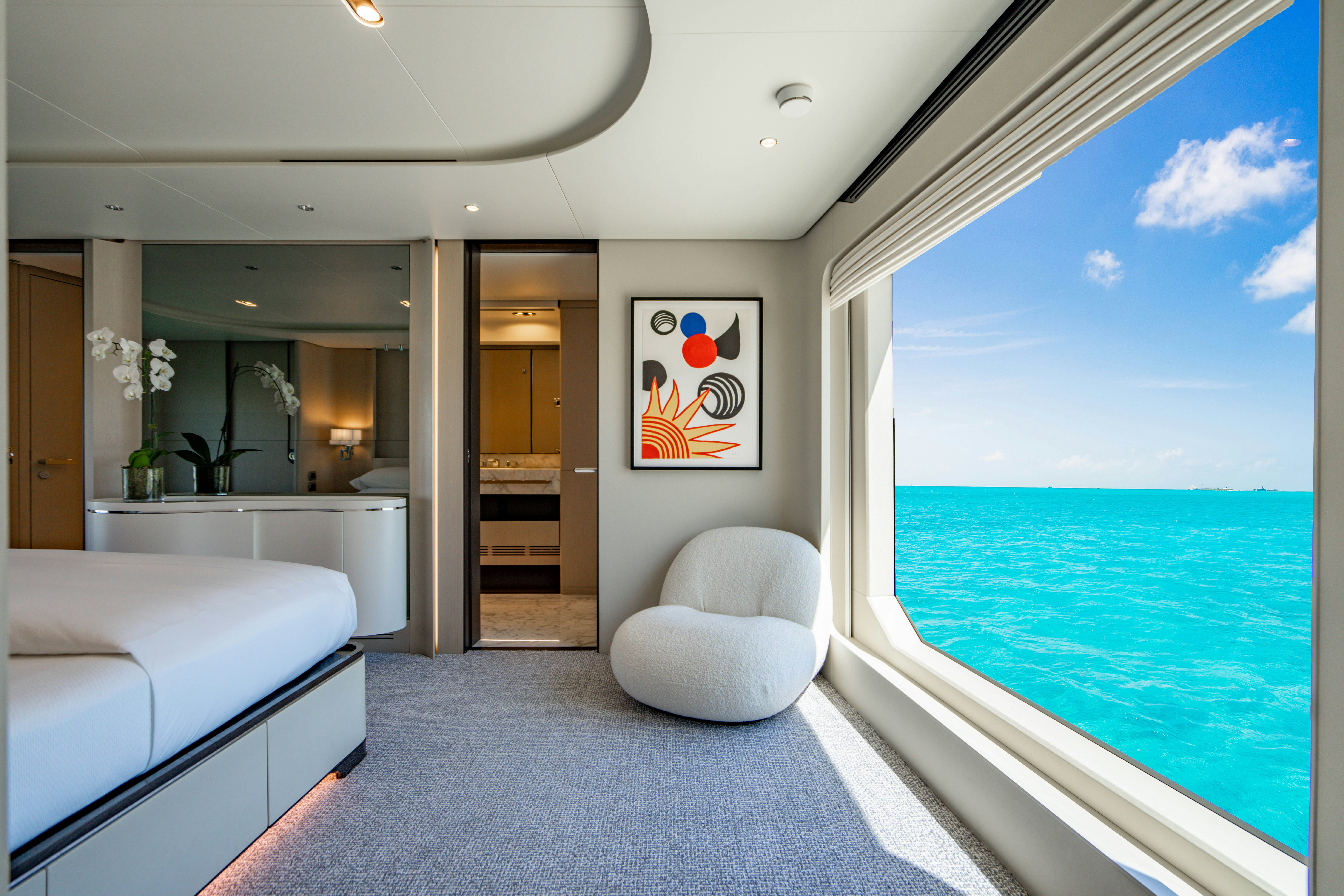 a room with a view of the ocean and a balcony aboard CARPE DIEM Yacht for Charter