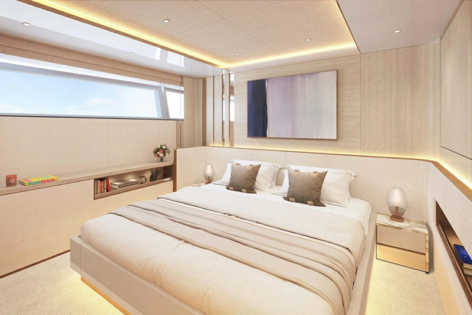 a room with a bed and a desk aboard XWAVE Yacht for Charter
