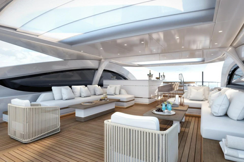 a modern living room with a large white sofa and white chairs aboard XWAVE Yacht for Charter
