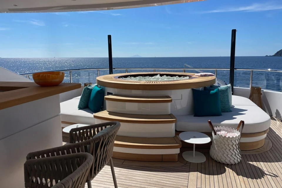 a table with chairs around it aboard XWAVE Yacht for Charter