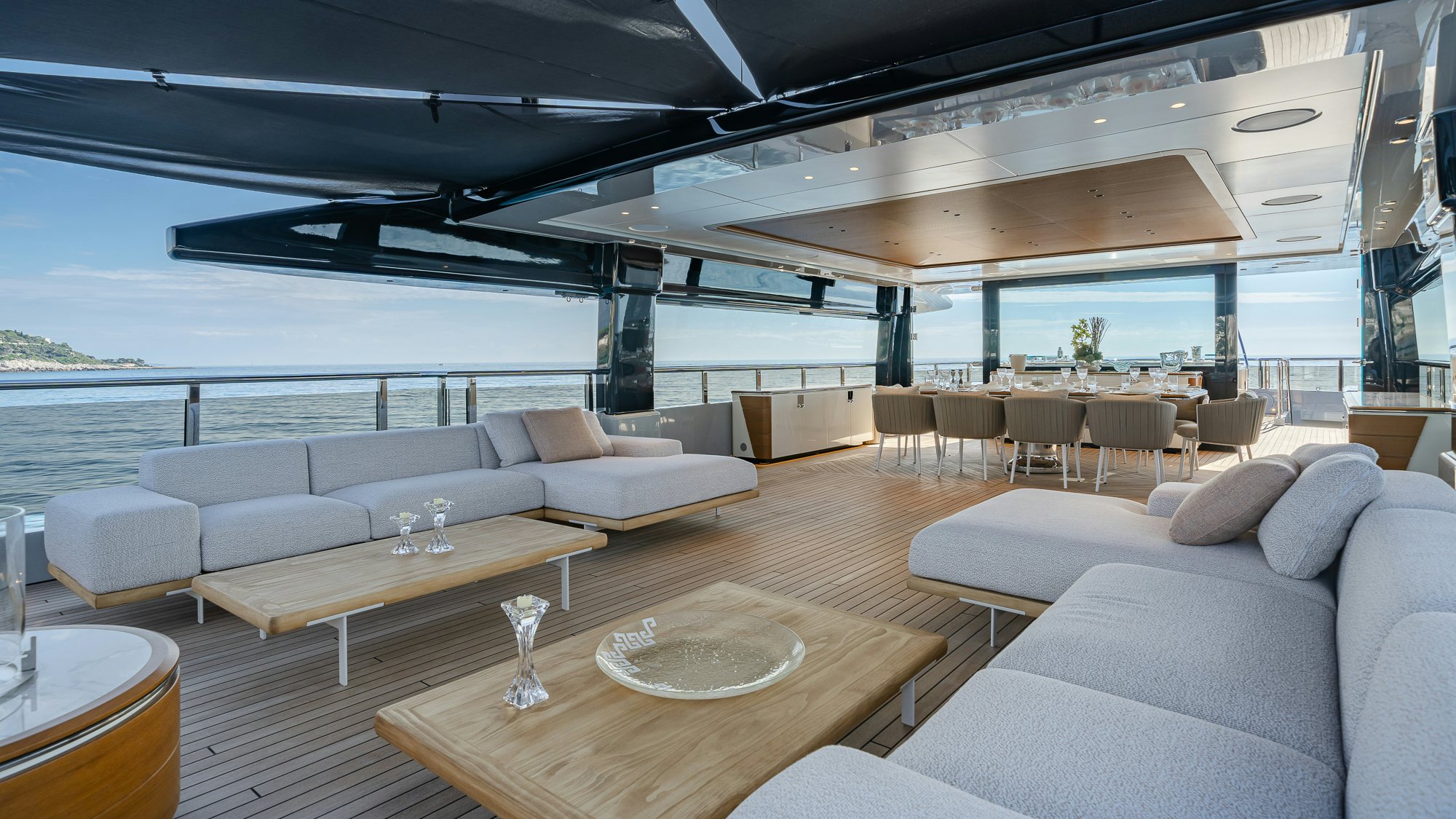 a room with a table and couches aboard SERENISSIMA I Yacht for Sale