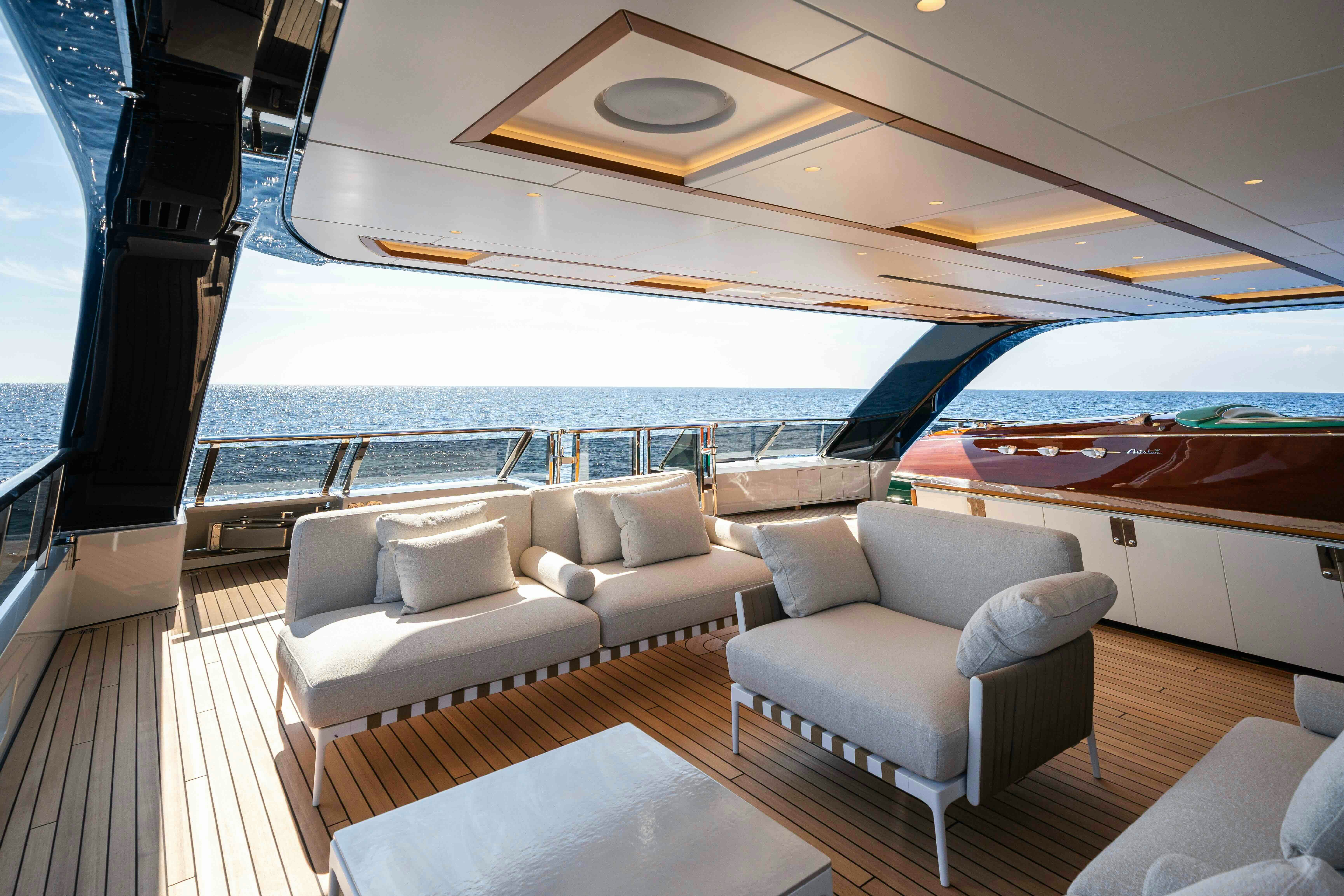 a boat with a couch and a table on a deck aboard SERENISSIMA I Yacht for Sale
