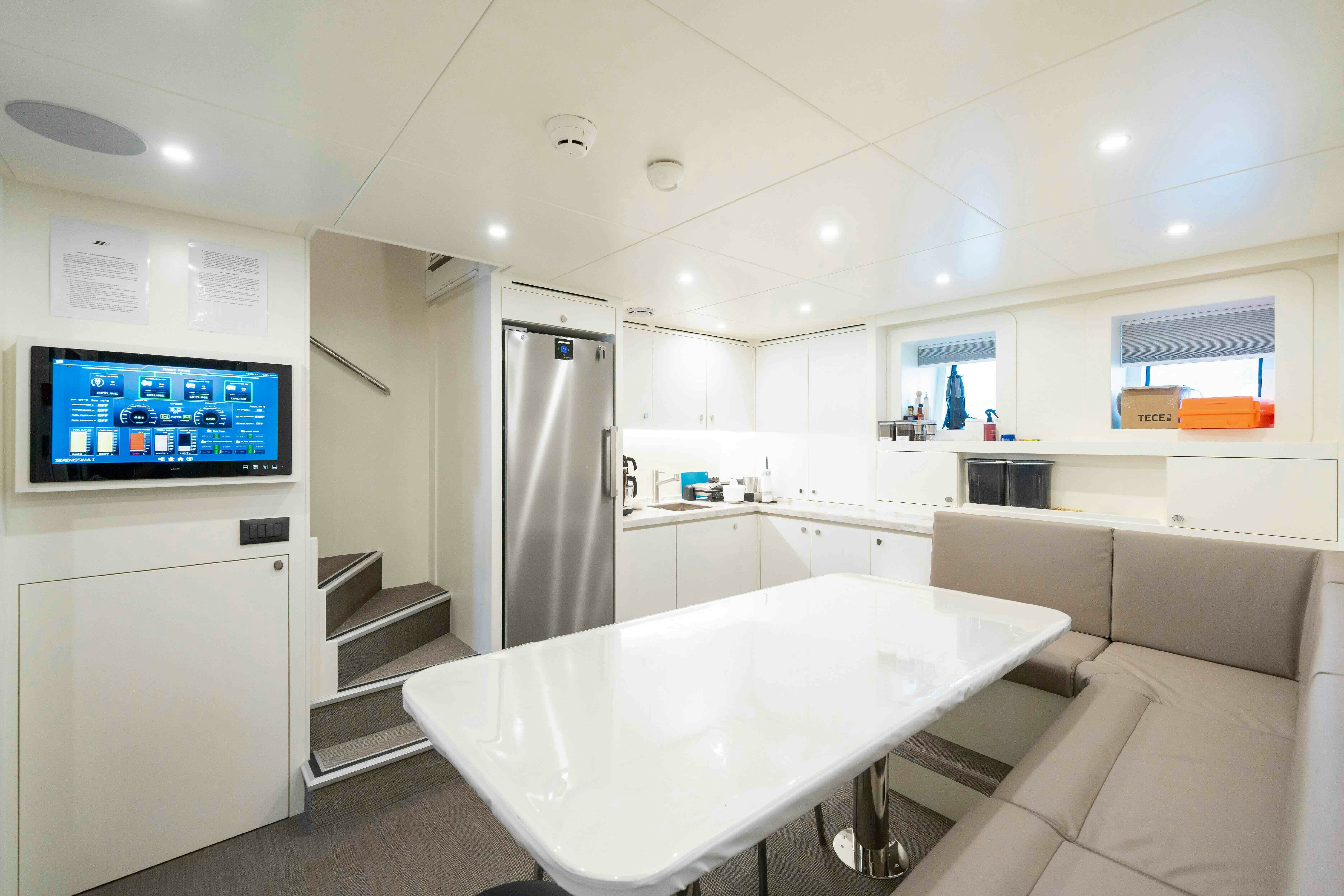 a large white kitchen with a large screen aboard SERENISSIMA I Yacht for Sale