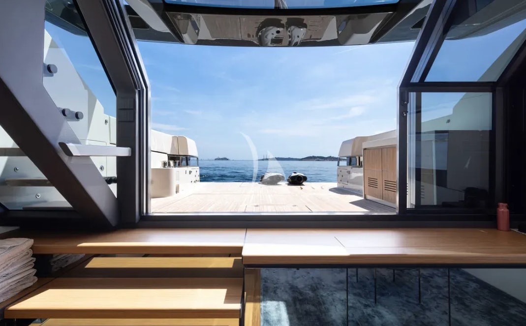 a room with a view of the water and the land below aboard CC Yacht for Charter