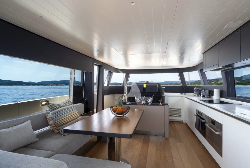a modern looking kitchen with a large open window aboard CC Yacht for Charter