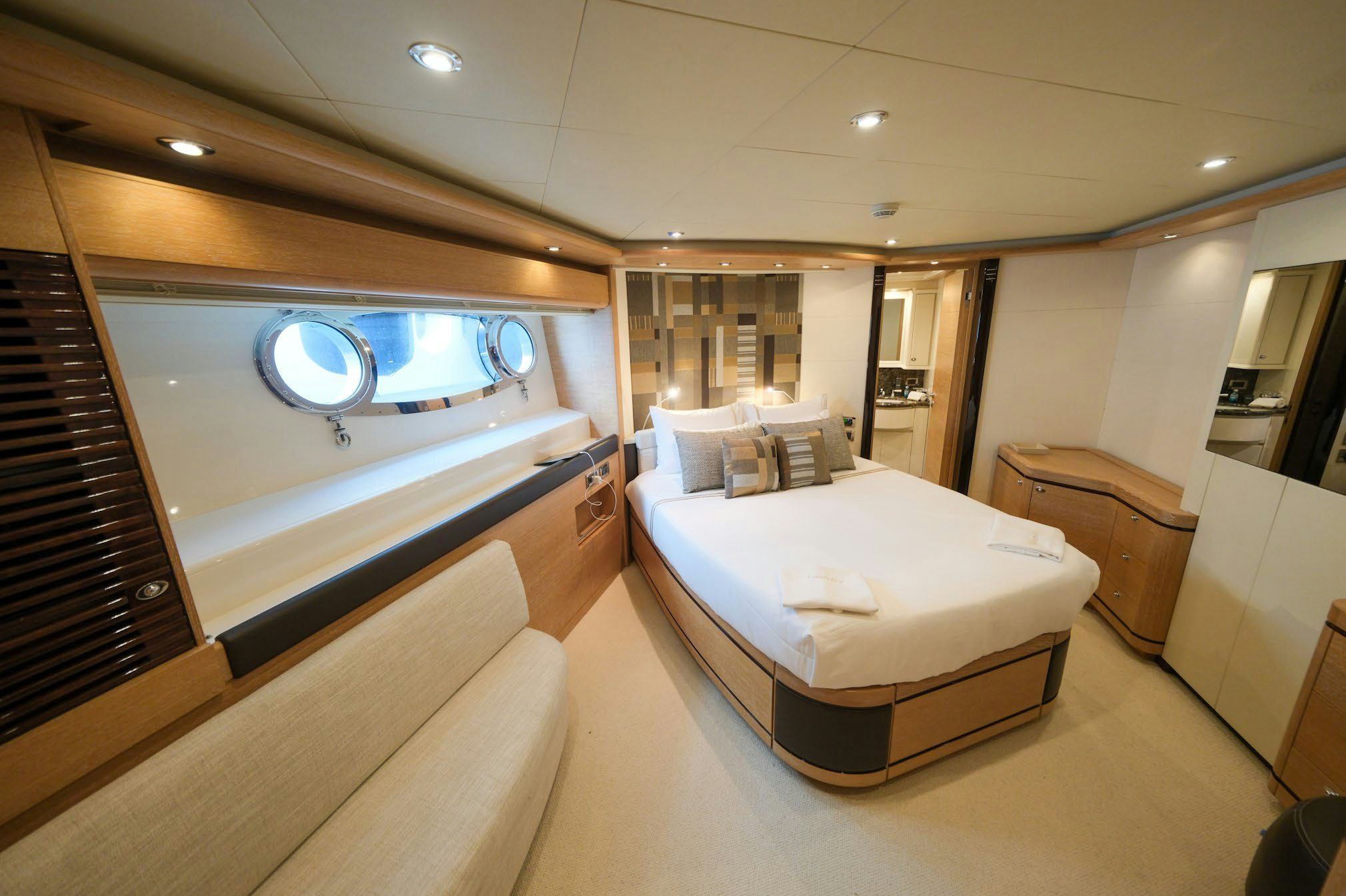 a room with a bed and a large mirror aboard AERO Yacht for Charter
