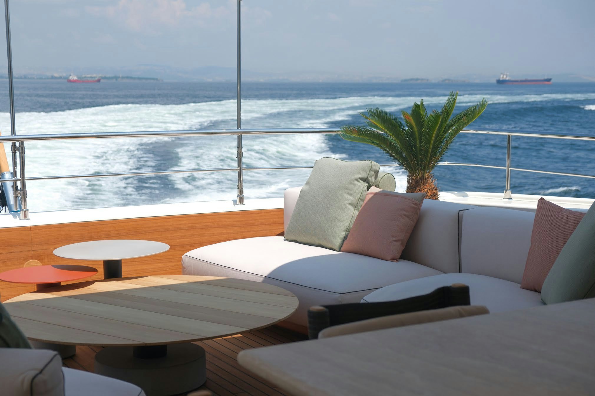 a room with a view of the ocean and a beach aboard AERO Yacht for Charter