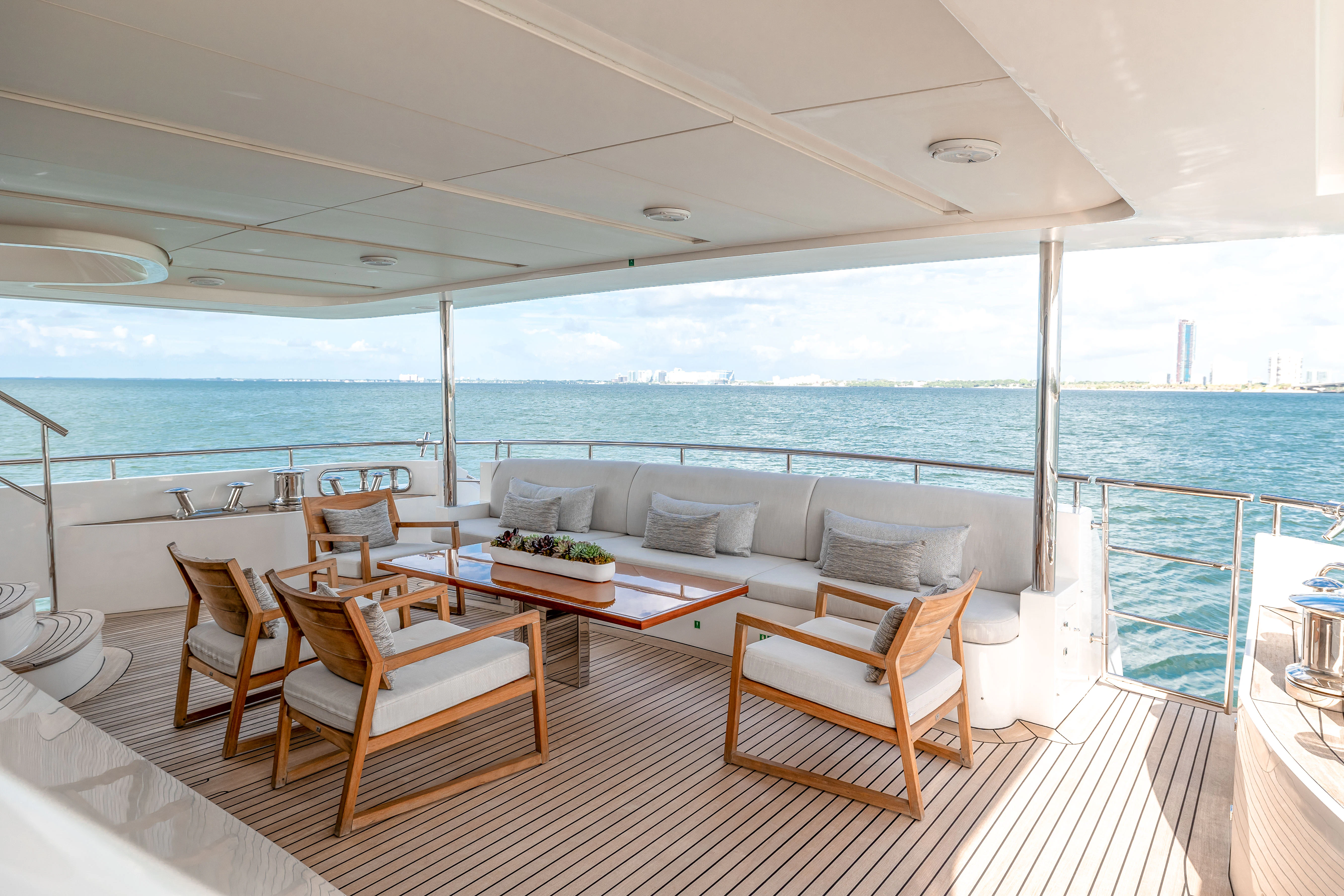 a large living room with a large balcony overlooking the ocean aboard PATIENCE Yacht for Charter