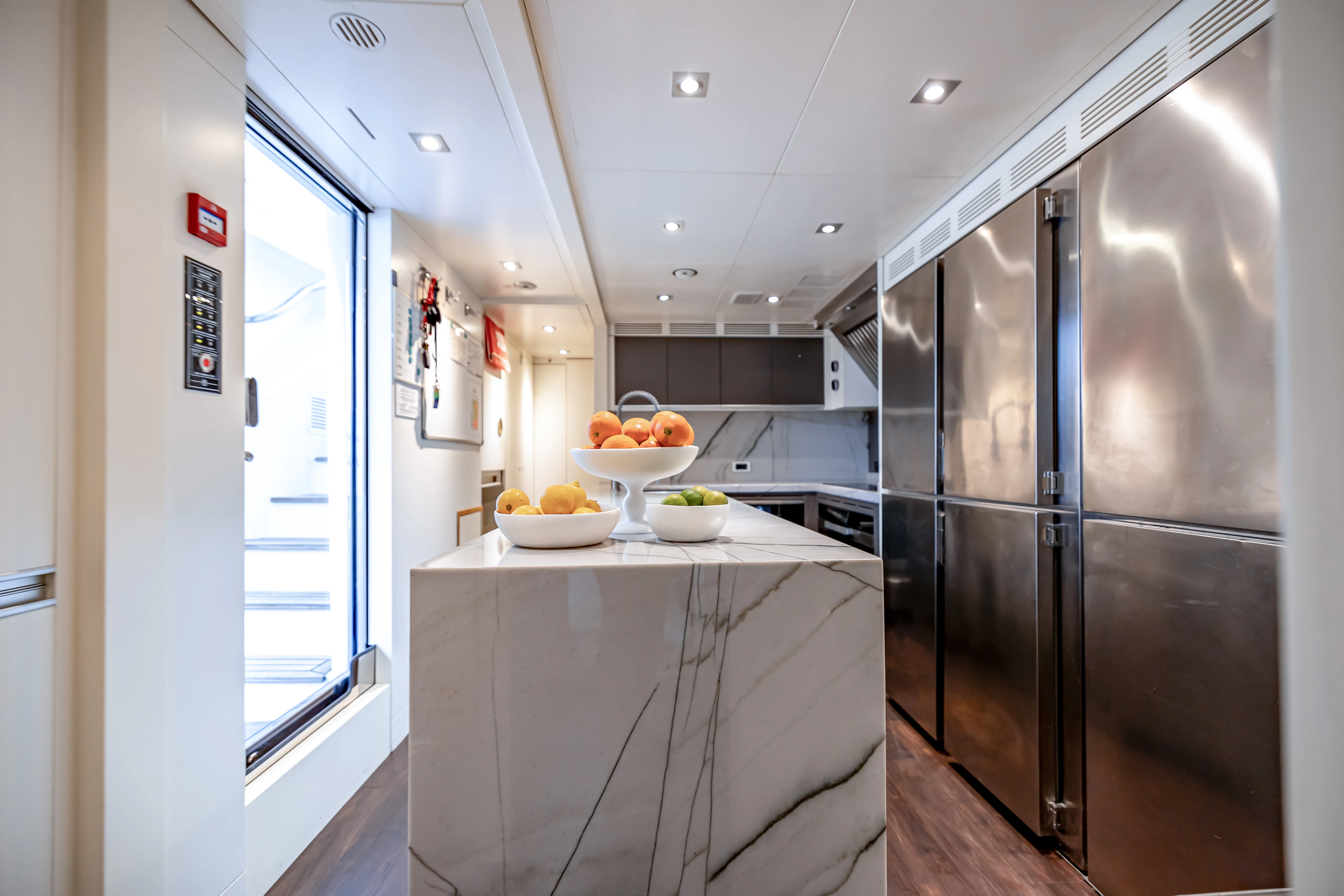 a kitchen with a stainless steel refrigerator aboard PATIENCE Yacht for Charter