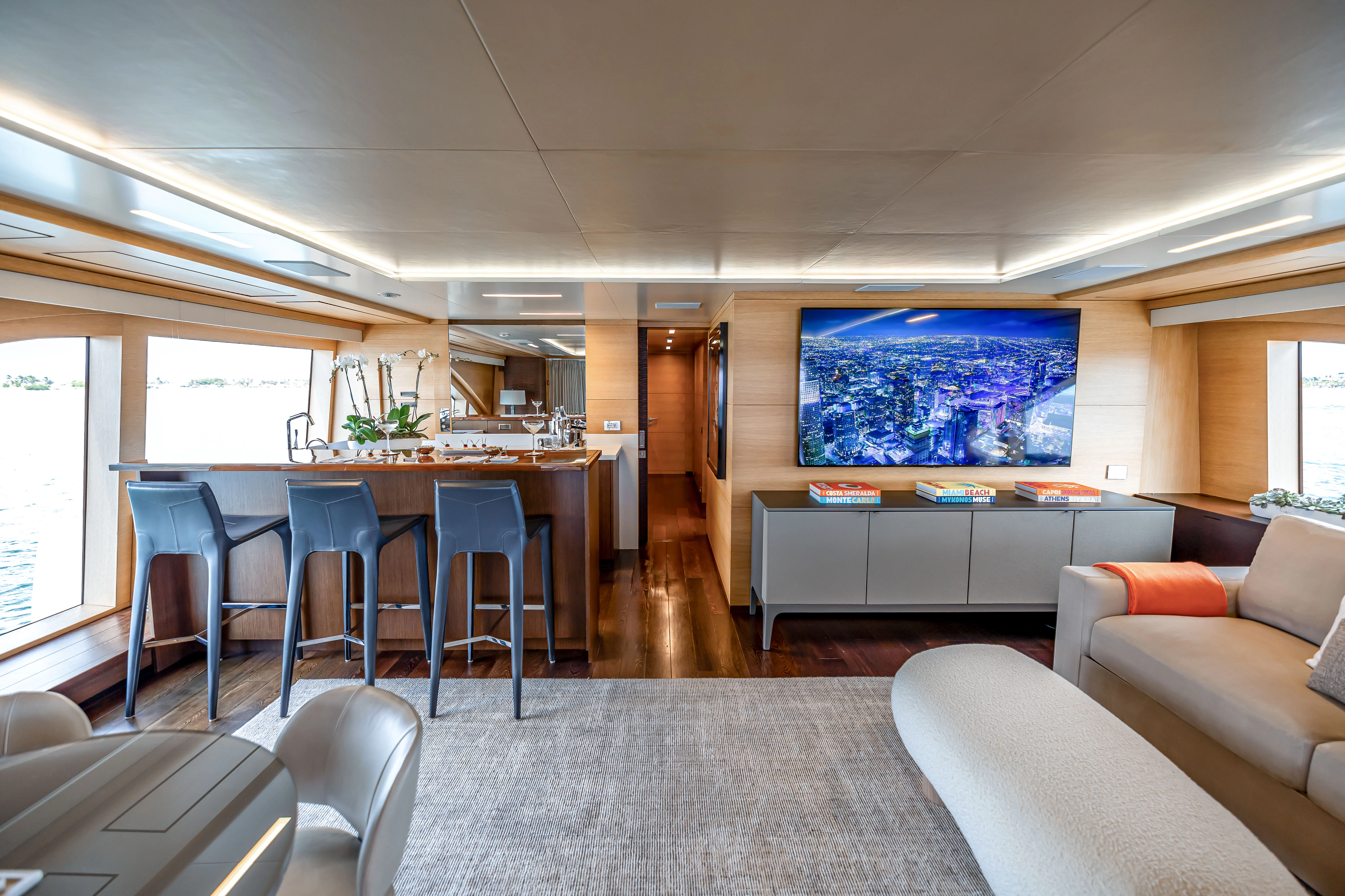 a room with a table chairs and a tv aboard PATIENCE Yacht for Charter