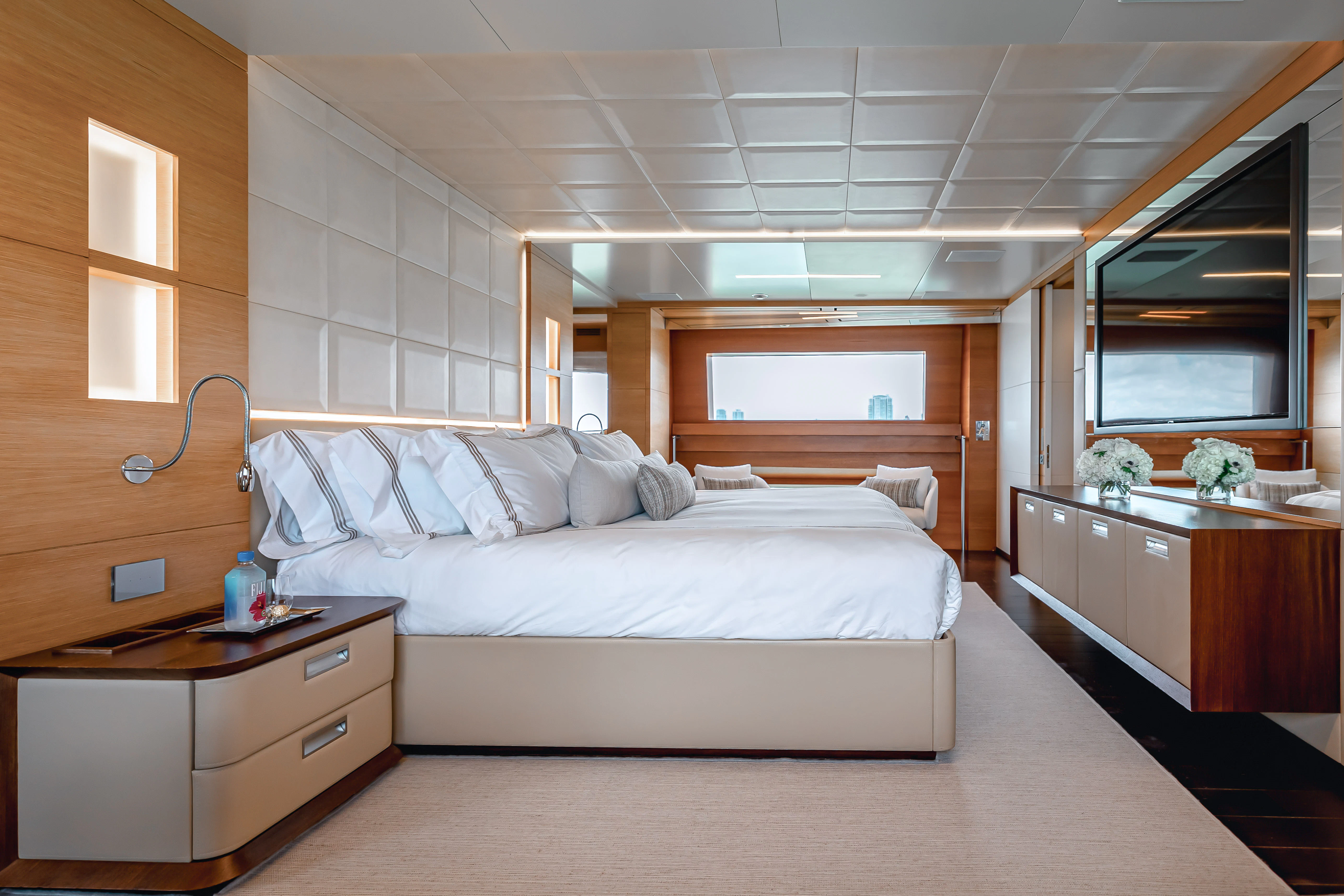 a bedroom with a bed and a desk aboard PATIENCE Yacht for Charter