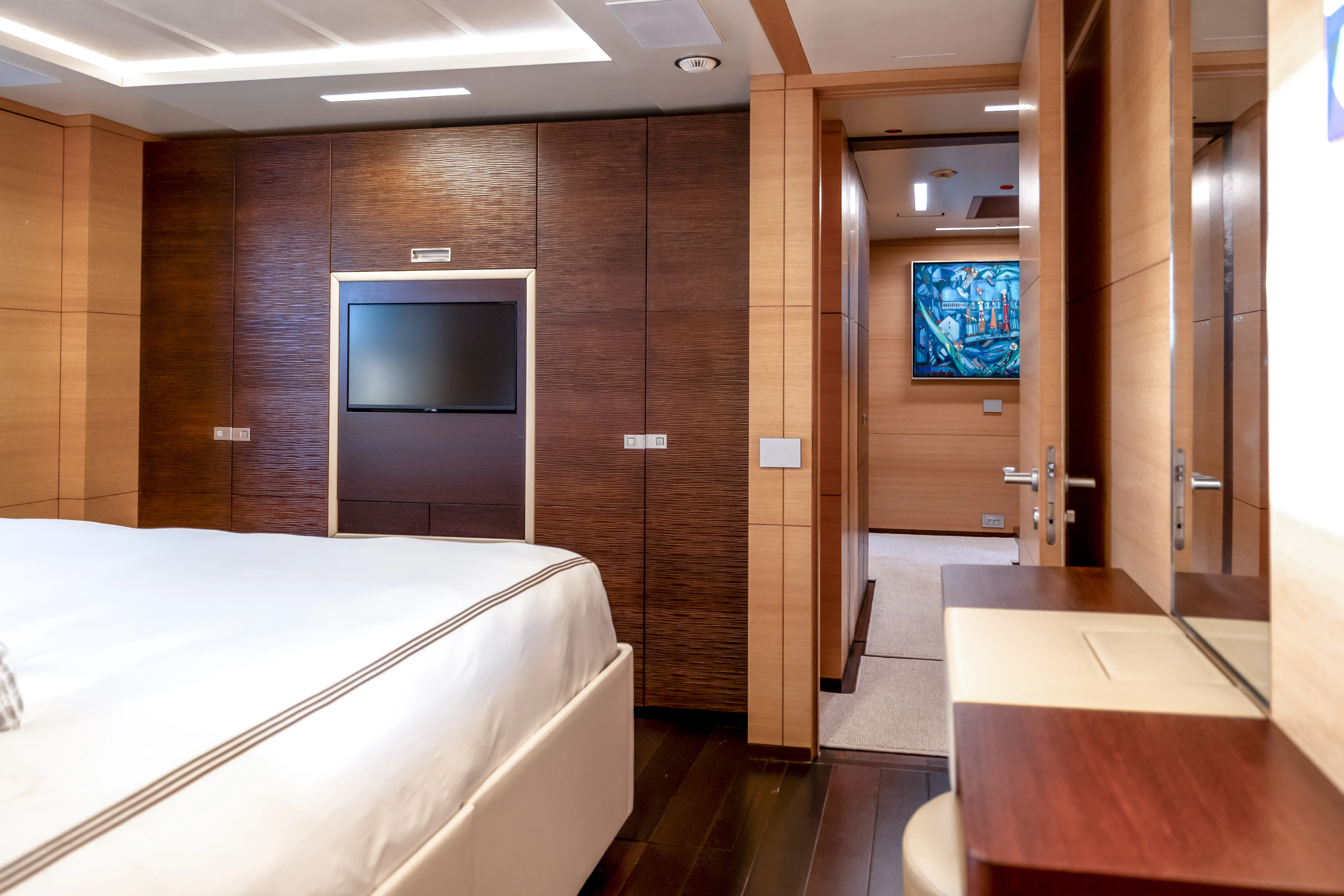 a room with a bed and a tv aboard PATIENCE Yacht for Charter