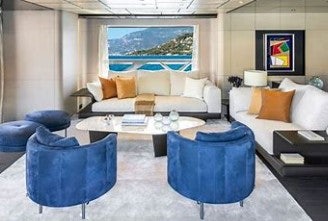 a living room with a large blue chair and a large blue rug aboard FELICITY Yacht for Charter
