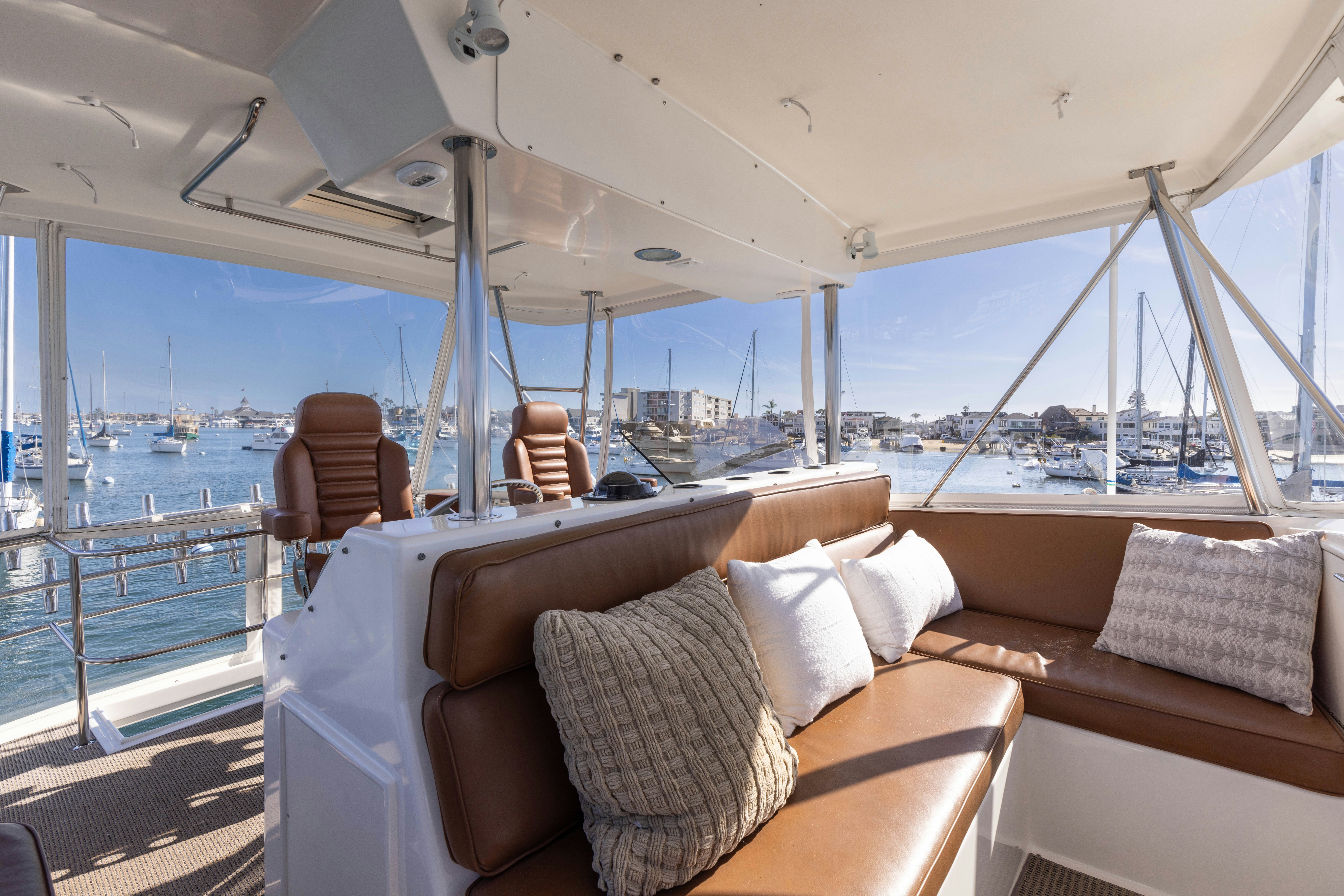a boat with pillows and a chair on a deck aboard LUCKY MARLIN Yacht for Sale