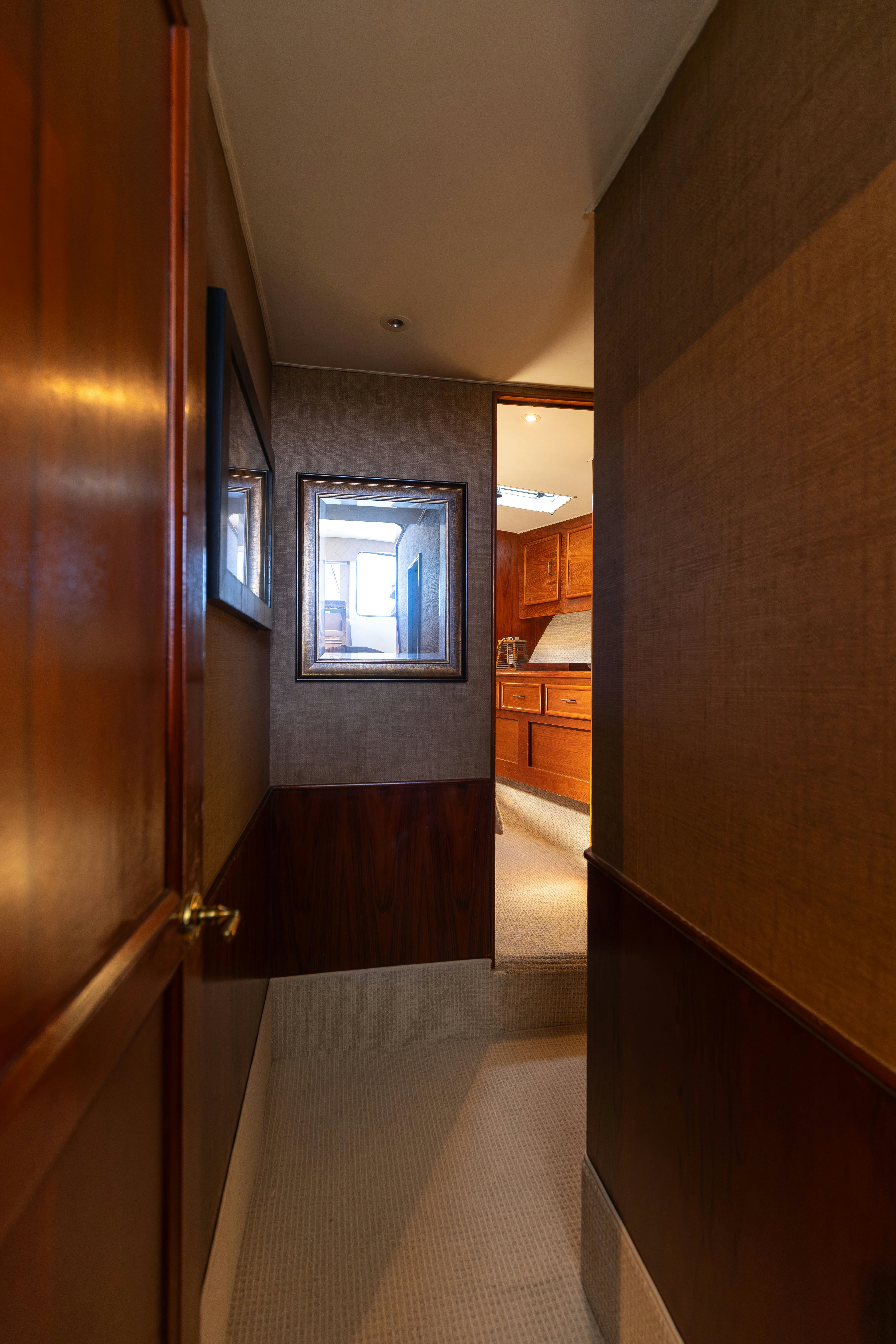 a hallway with a television on the wall aboard LUCKY MARLIN Yacht for Sale
