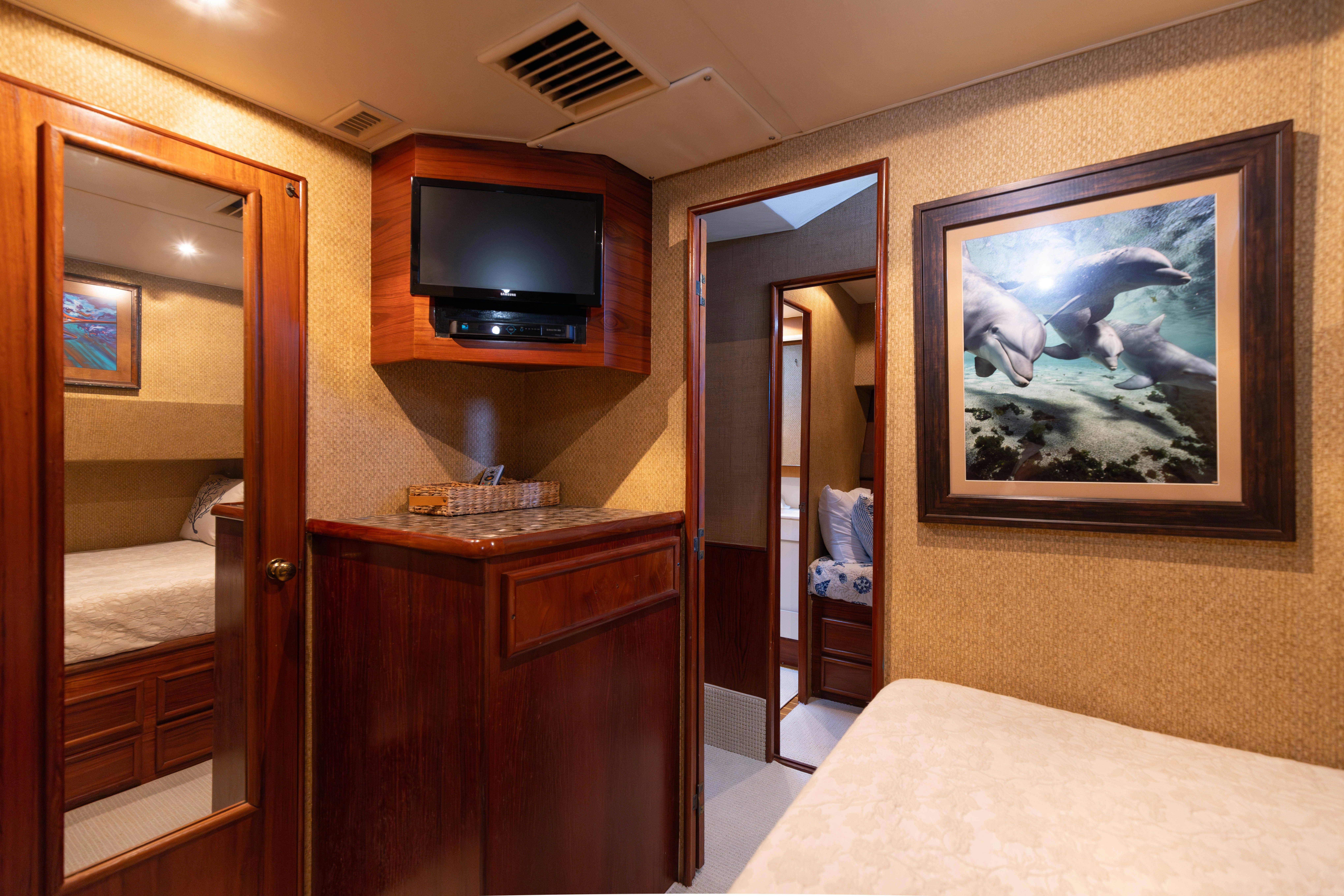 a bedroom with a bed and a television aboard LUCKY MARLIN Yacht for Sale