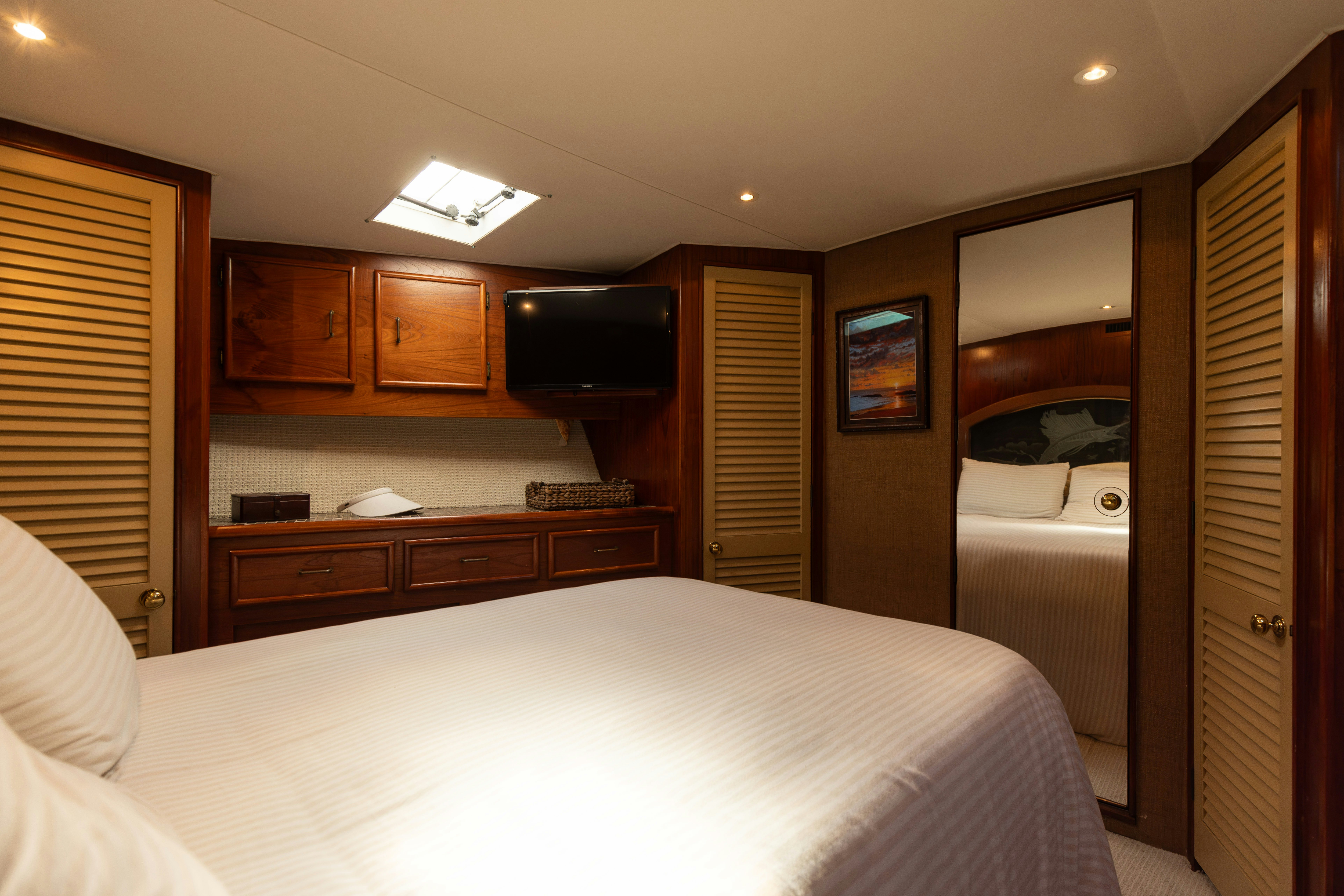 a bedroom with a bed and a television aboard LUCKY MARLIN Yacht for Sale