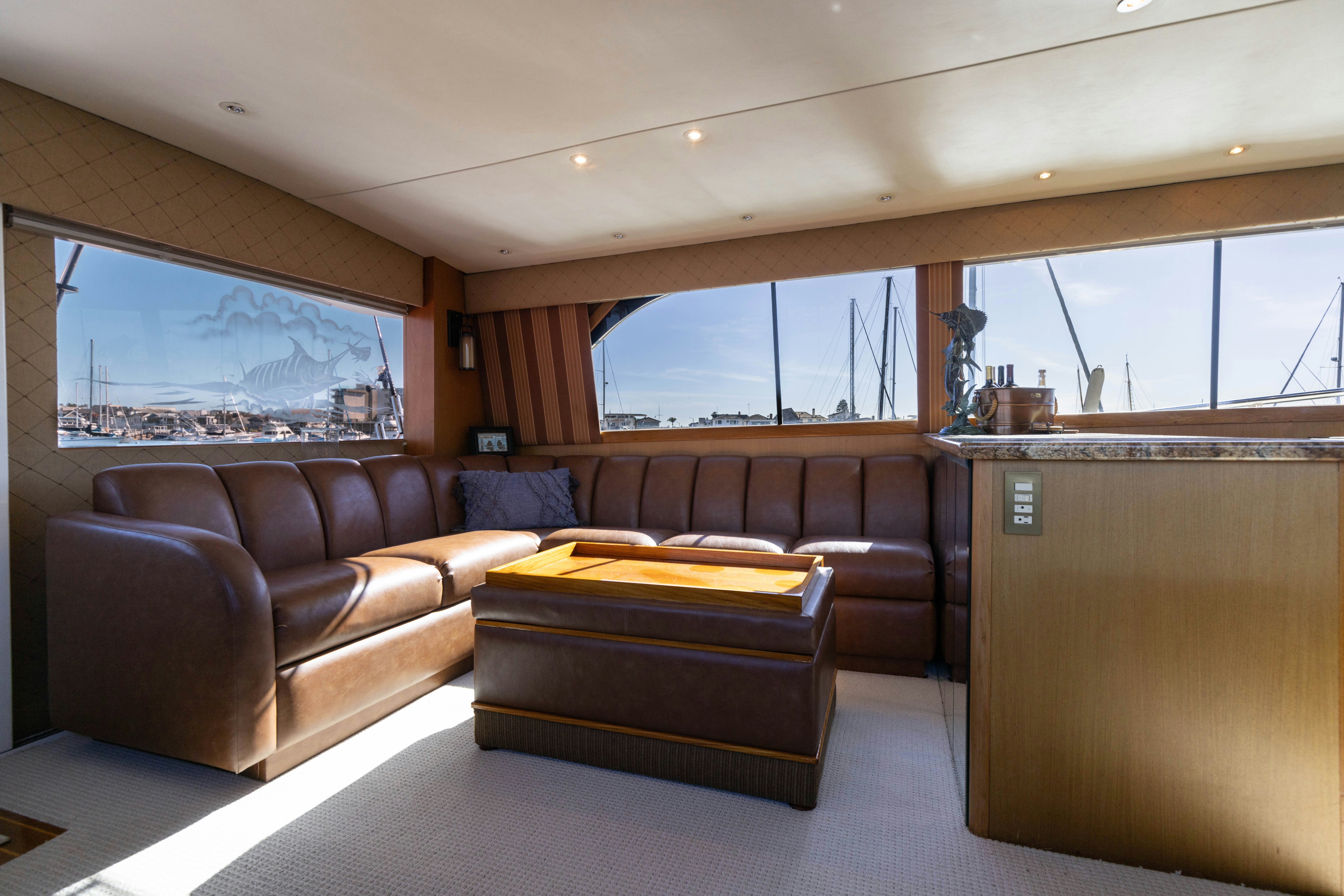 a living room with leather couches aboard LUCKY MARLIN Yacht for Sale