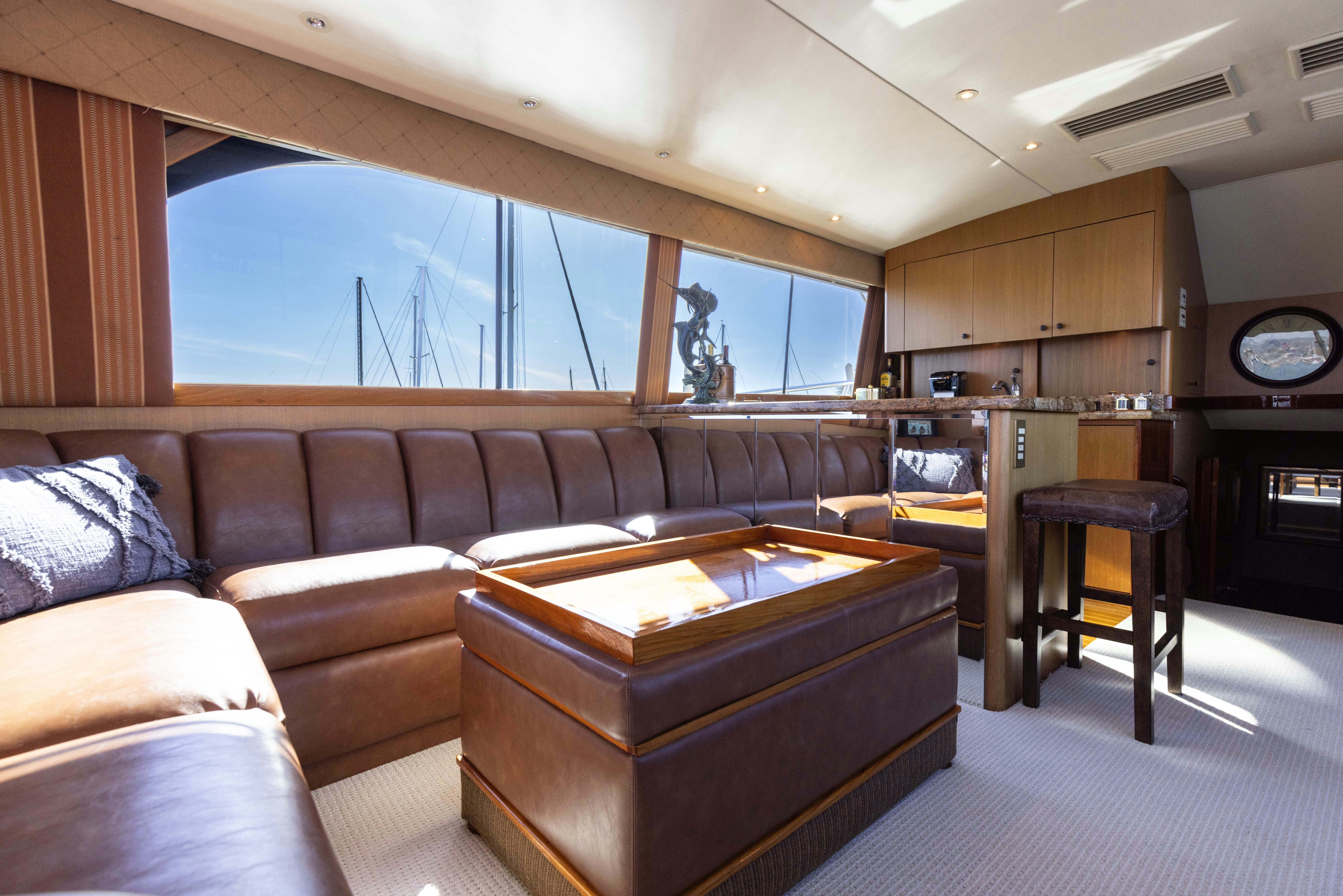 a living room with a couch and a piano aboard LUCKY MARLIN Yacht for Sale